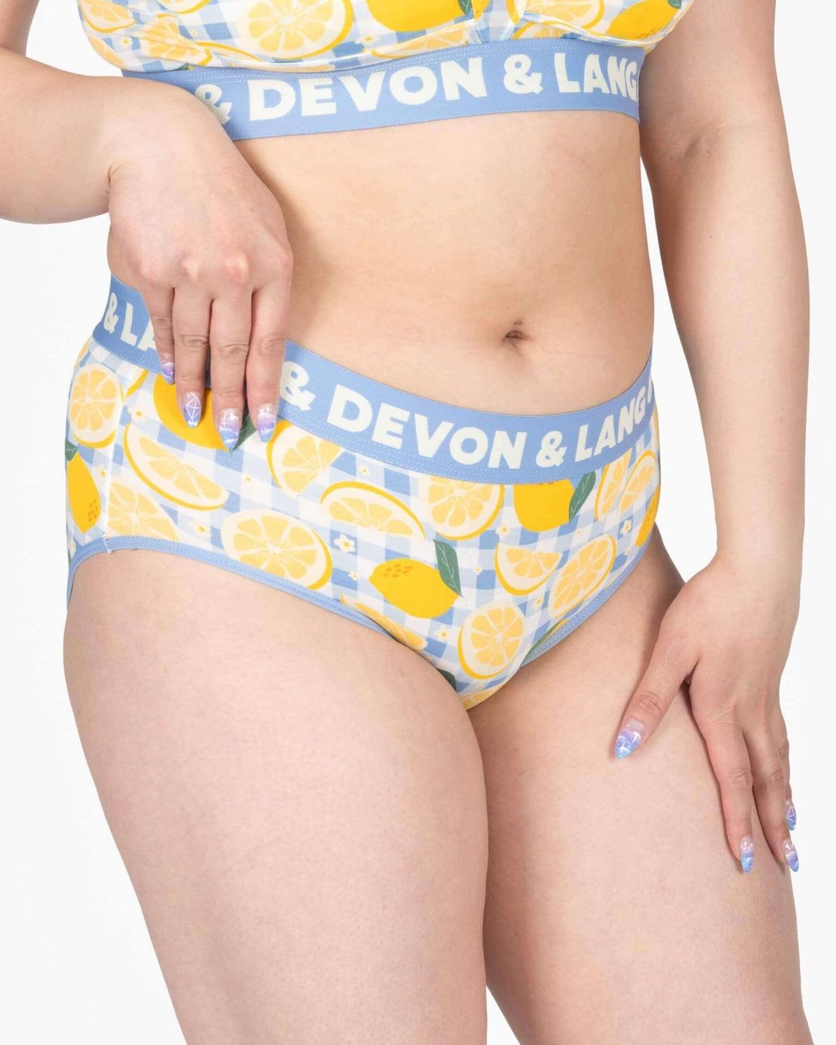 Model wearing Devon + Lang Bria Full Coverage Bikini Brief with lemon print, showcasing comfort and style.