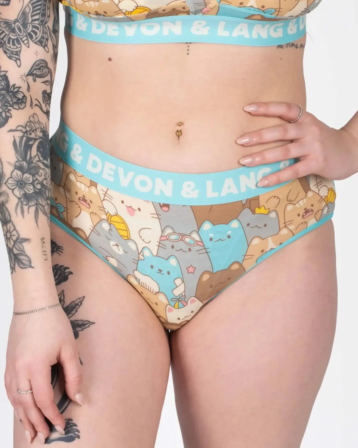 Model showcasing Devon + Lang Bria Full Coverage Bikini Brief with cat print design.