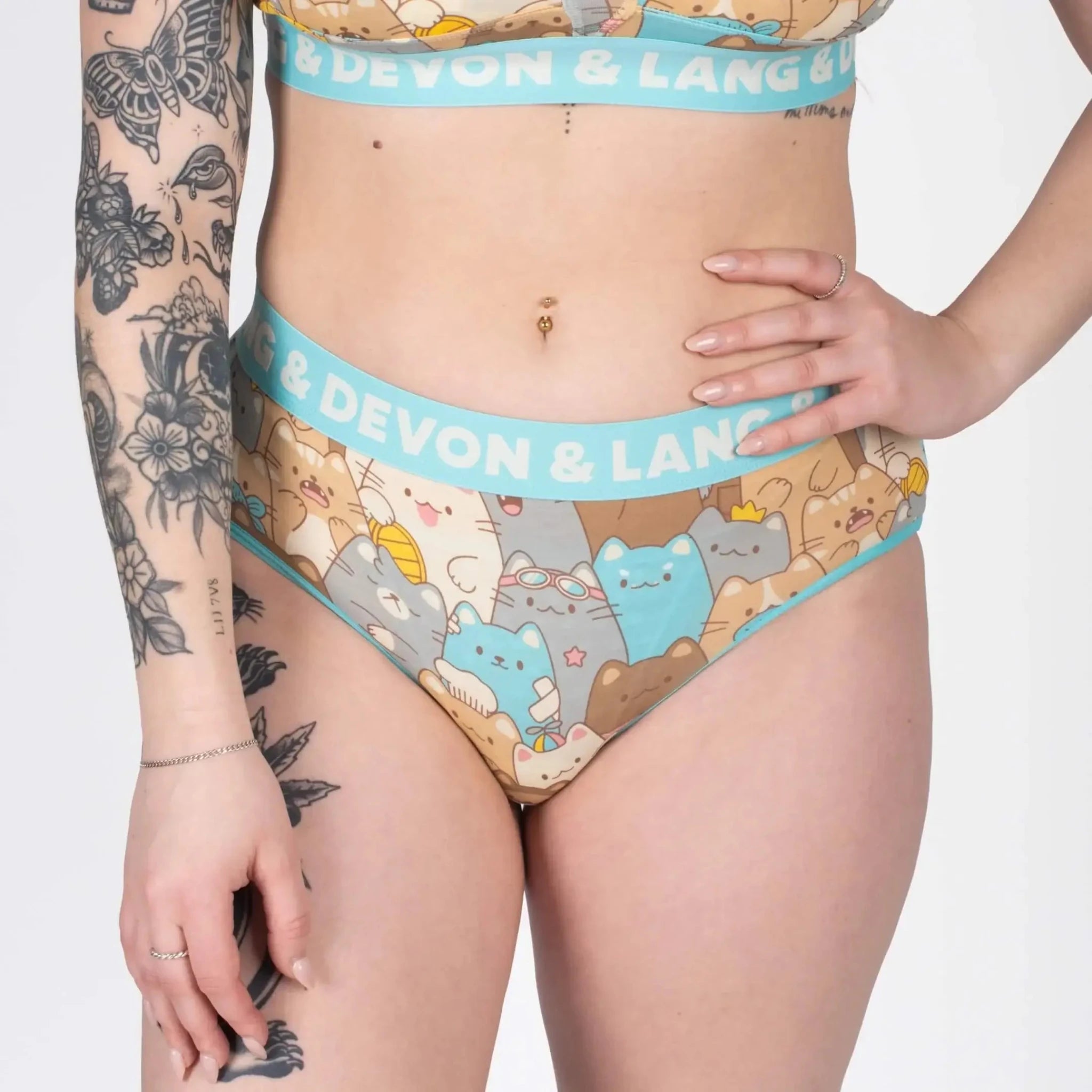 Model showcasing Devon + Lang Bria Full Coverage Bikini Brief with cat print design.