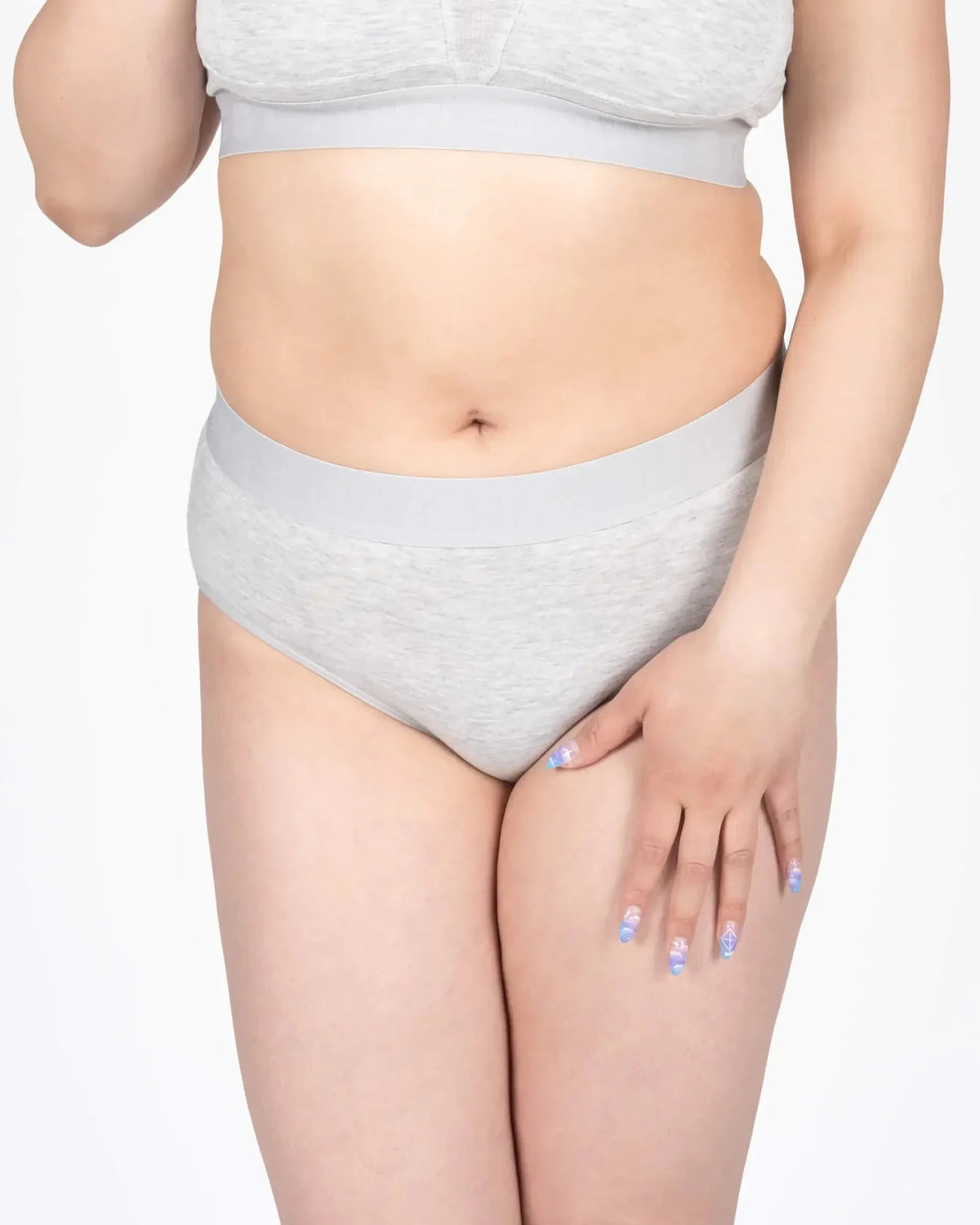 Model wearing Devon + Lang Bria Full Coverage Bikini Brief in light gray.