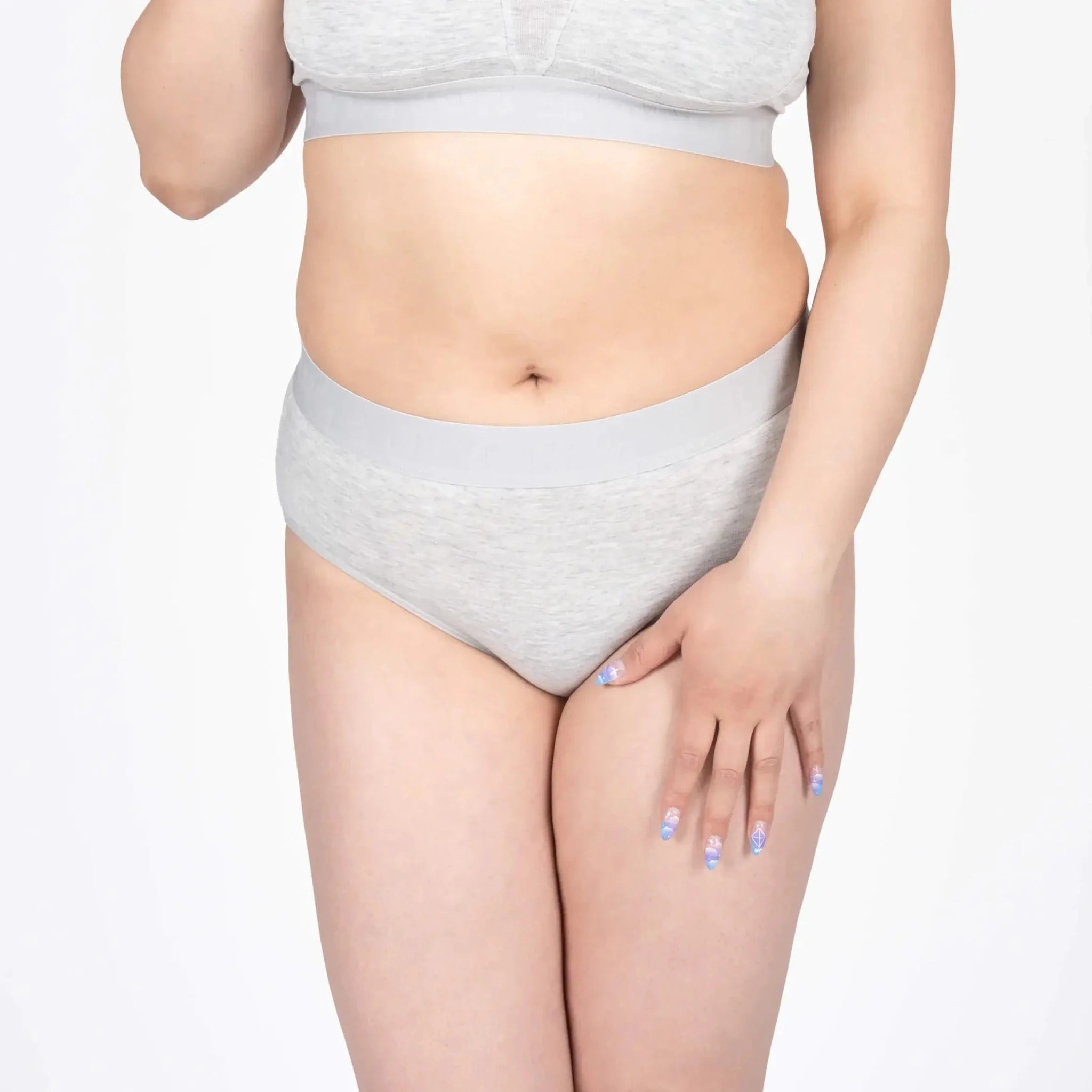Model wearing Devon + Lang Bria Full Coverage Bikini Brief in light gray.