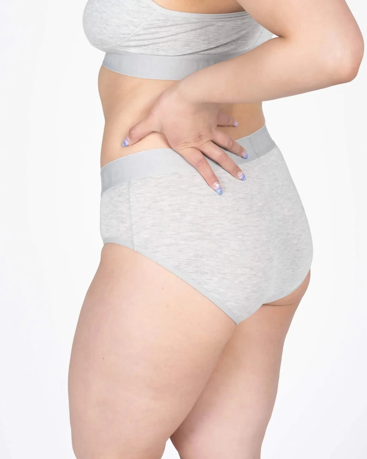 Model wearing the Devon + Lang Bria Full Coverage Bikini Brief in grey, showcasing its comfort and fit.