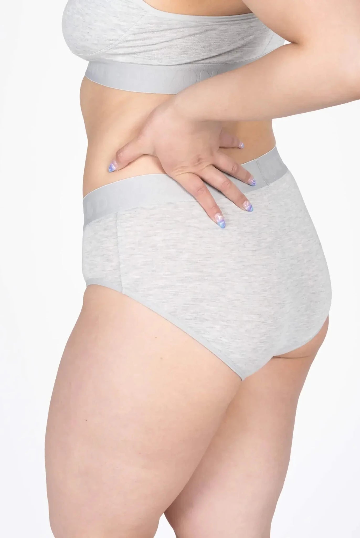 Model wearing the Devon + Lang Bria Full Coverage Bikini Brief in grey, showcasing its comfort and fit.