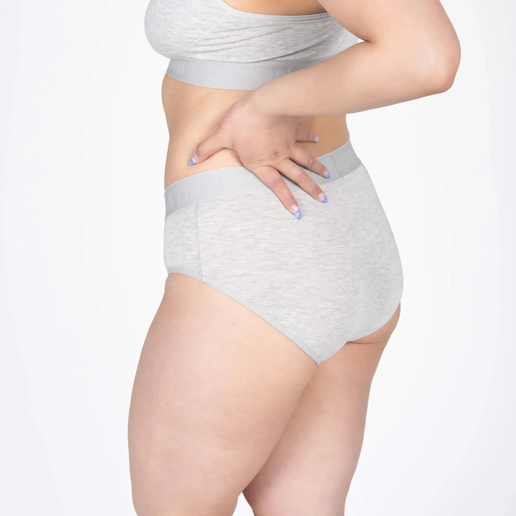 Model wearing the Devon + Lang Bria Full Coverage Bikini Brief in grey, showcasing its comfort and fit.