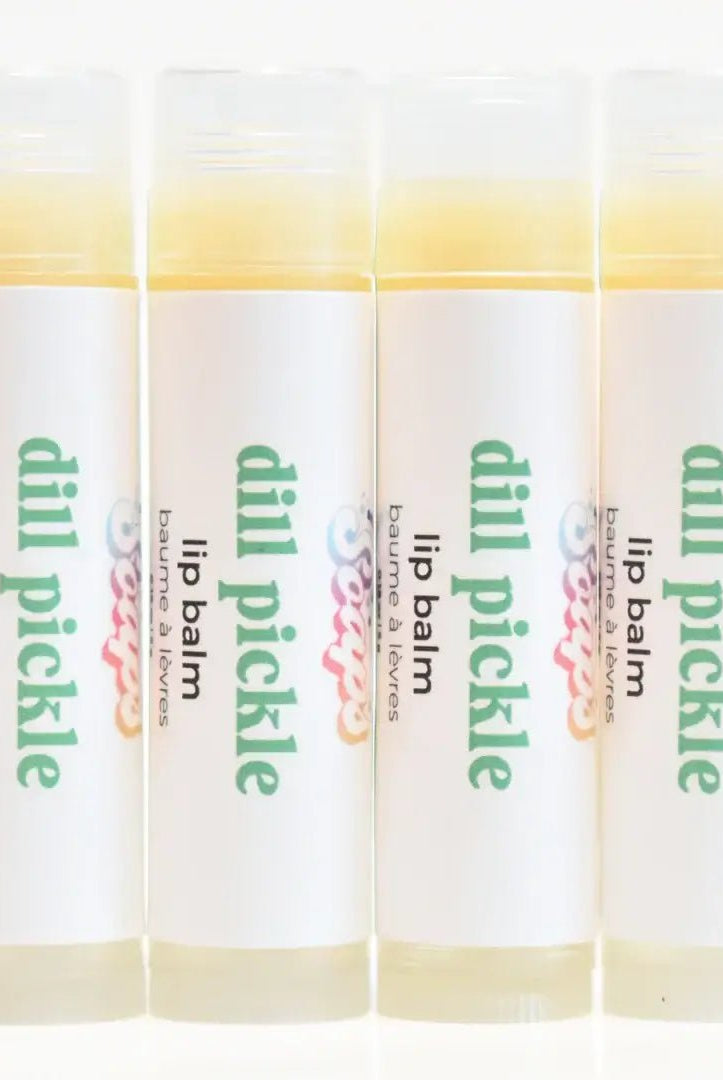 Dill Pickle Lip Balm tubes arranged in a row, featuring a crunchy dill pickle flavor and hydrating ingredients.