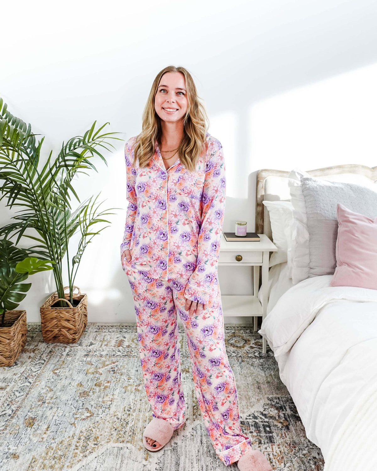 Dream in Blooms Long Sleeve Button Up & Pant Bamboo Lounge Set worn by a model in a cozy bedroom setting.
