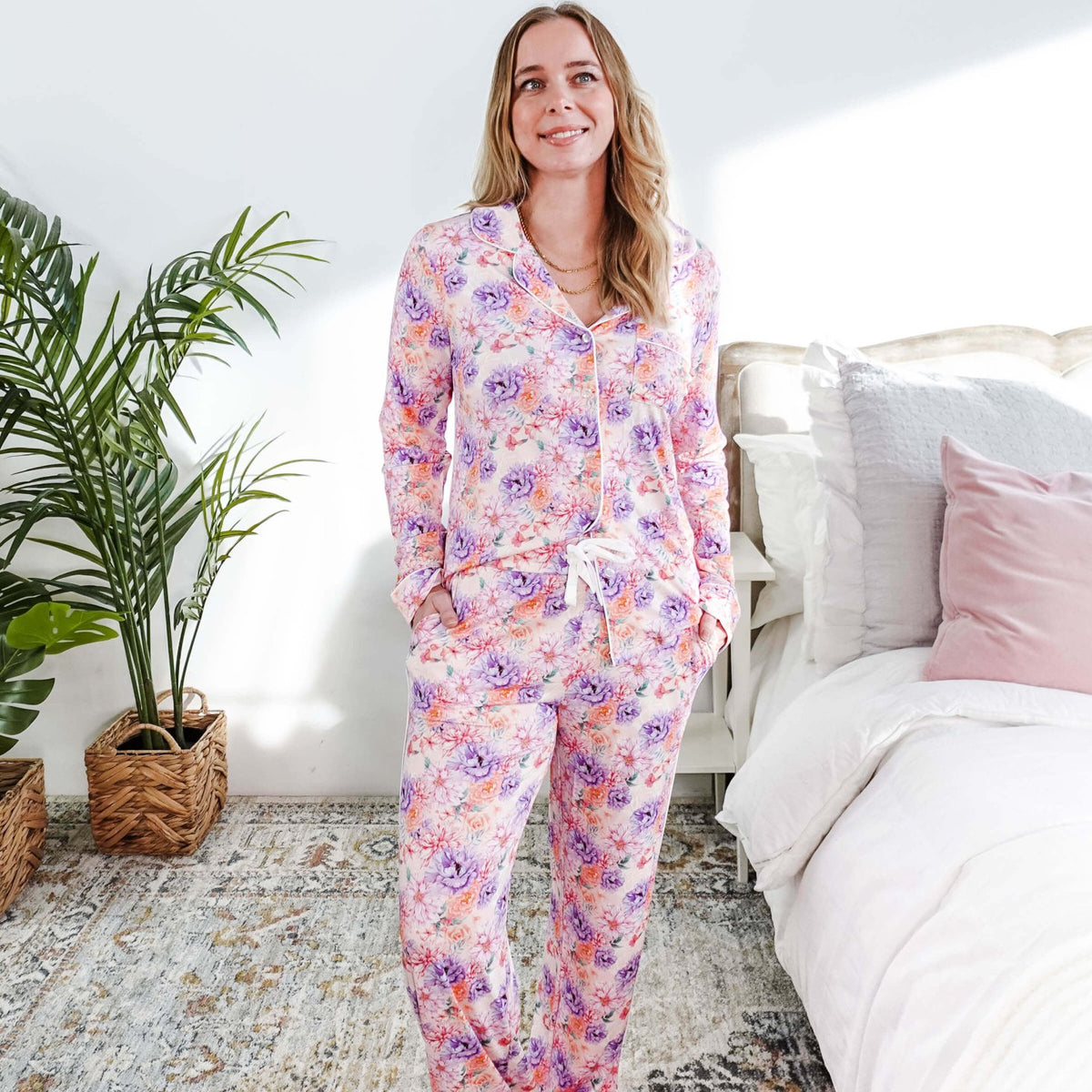 Woman wearing the Dream in Blooms Long Sleeve Button Up & Pant Bamboo Lounge Set in a bright room.