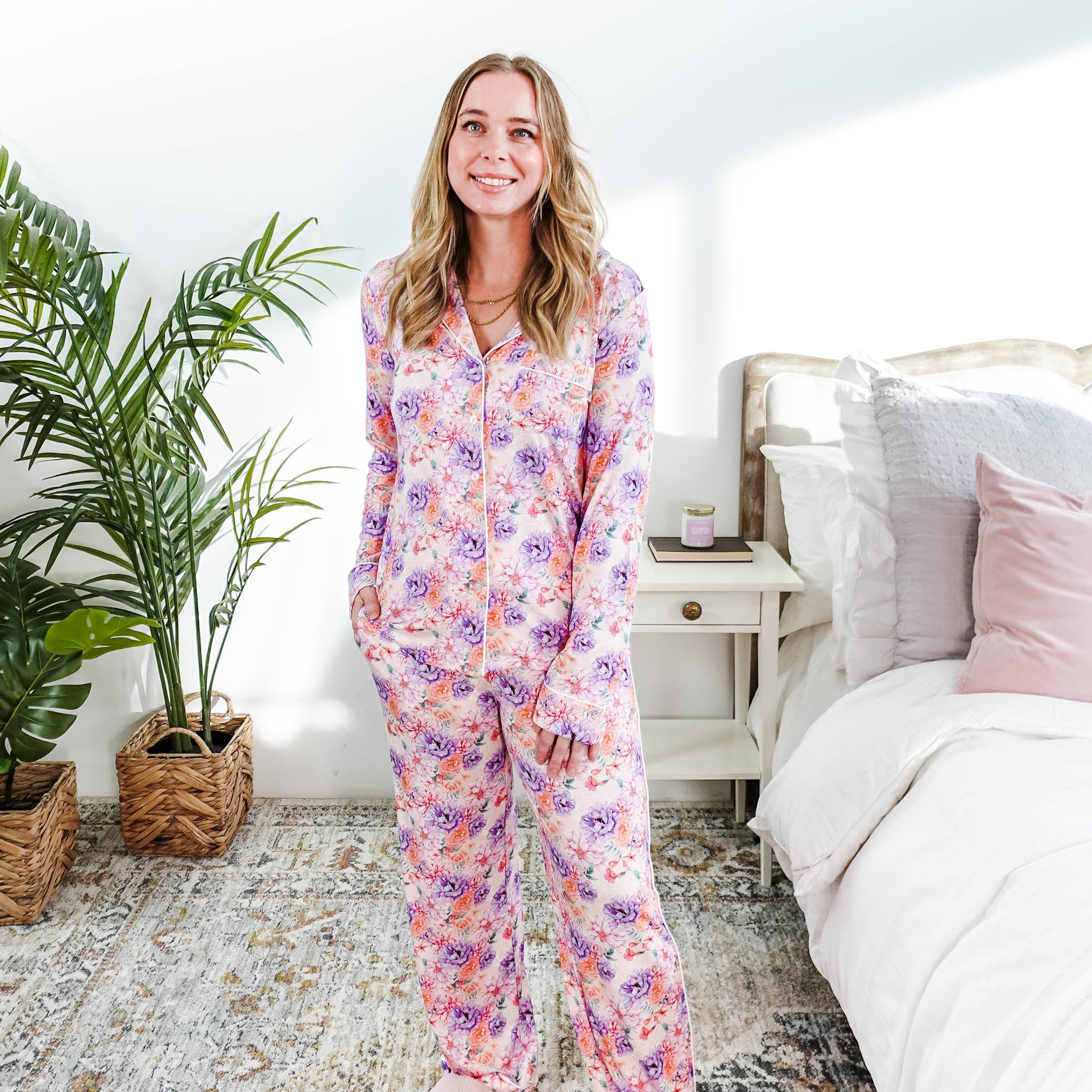 Dream in Blooms Long Sleeve Button Up & Pant Bamboo Lounge Set worn by a model in a cozy bedroom setting.