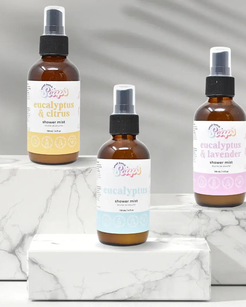 Eucalyptus Shower Mist bottles displayed on marble surface, highlighting eucalyptus & citrus, classic eucalyptus, and eucalyptus & lavender scents.
