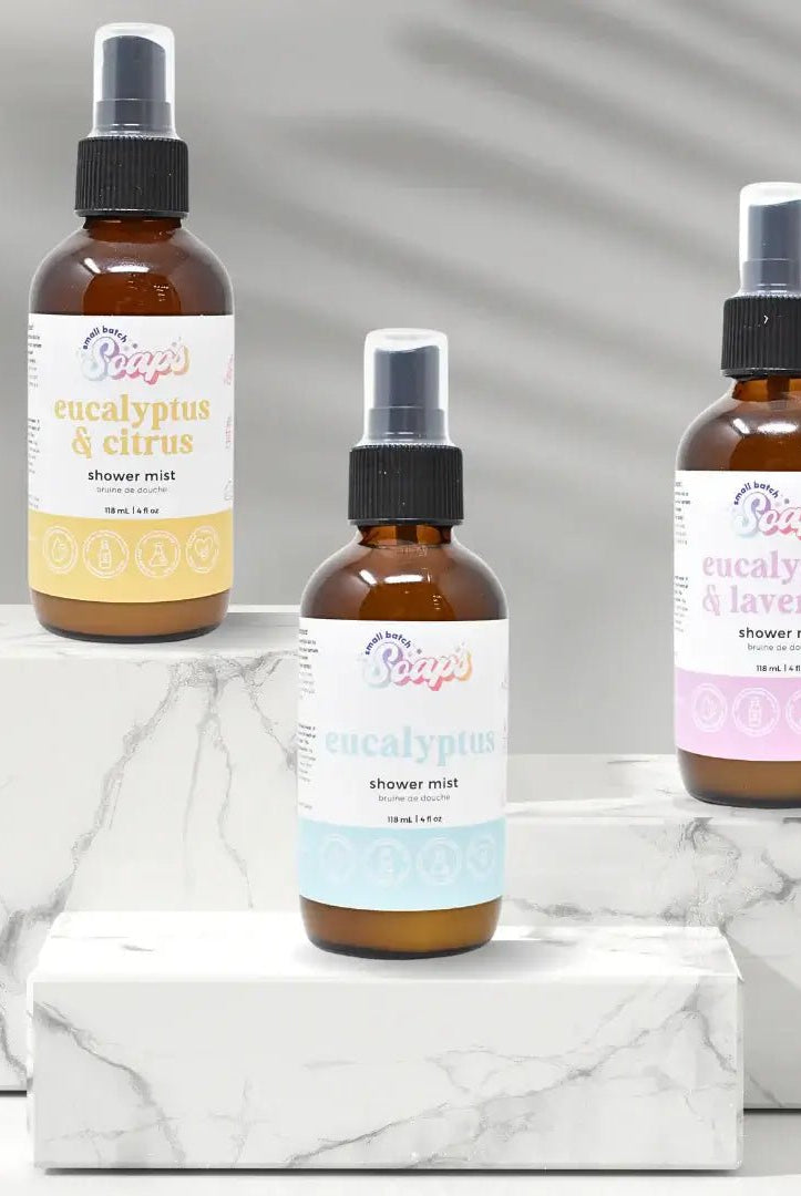 Eucalyptus Shower Mist bottles displayed on marble surface, highlighting eucalyptus & citrus, classic eucalyptus, and eucalyptus & lavender scents.