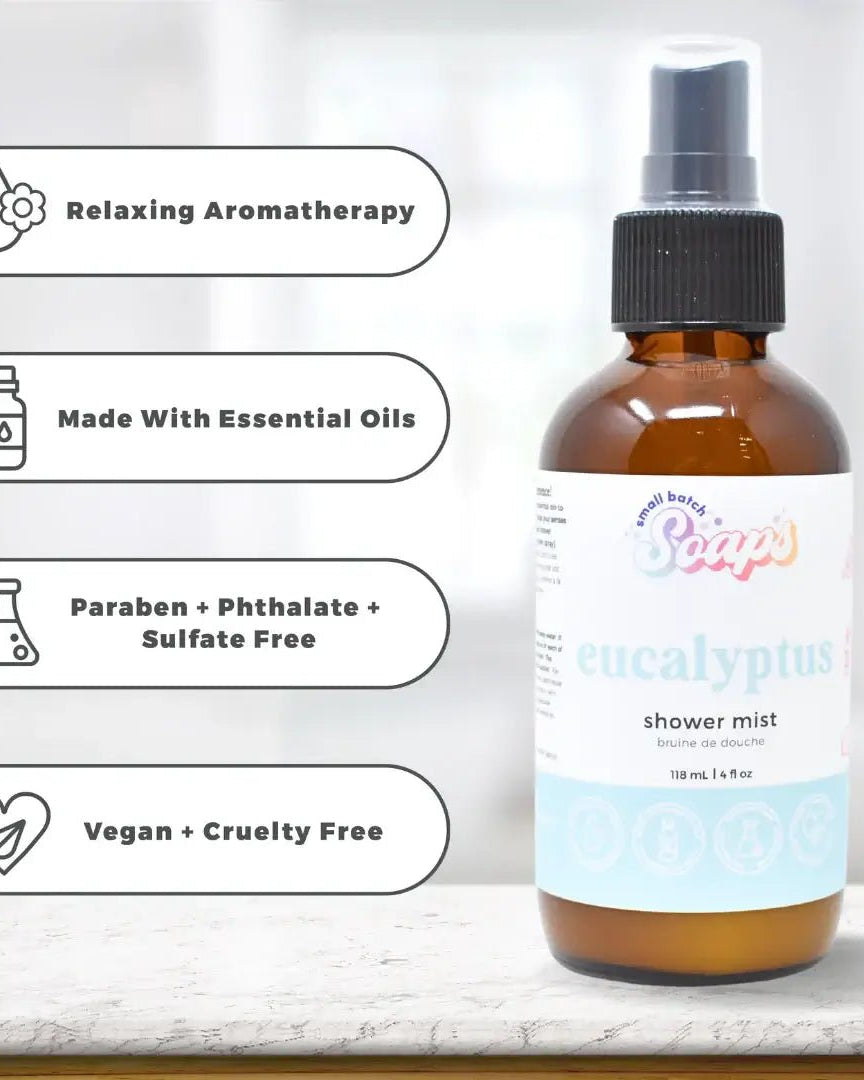 Eucalyptus Shower Mist bottle with labels highlighting essential oils and vegan ingredients on a light background.