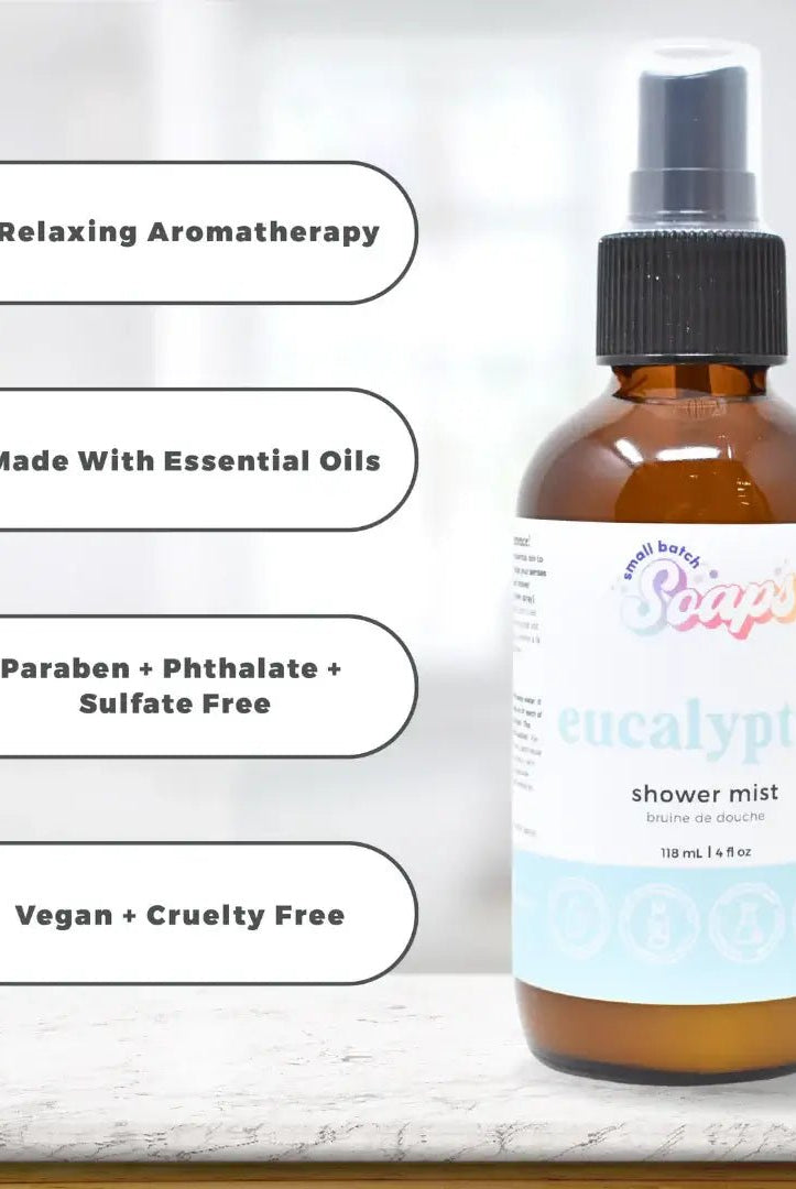 Eucalyptus Shower Mist bottle with labels highlighting essential oils and vegan ingredients on a light background.
