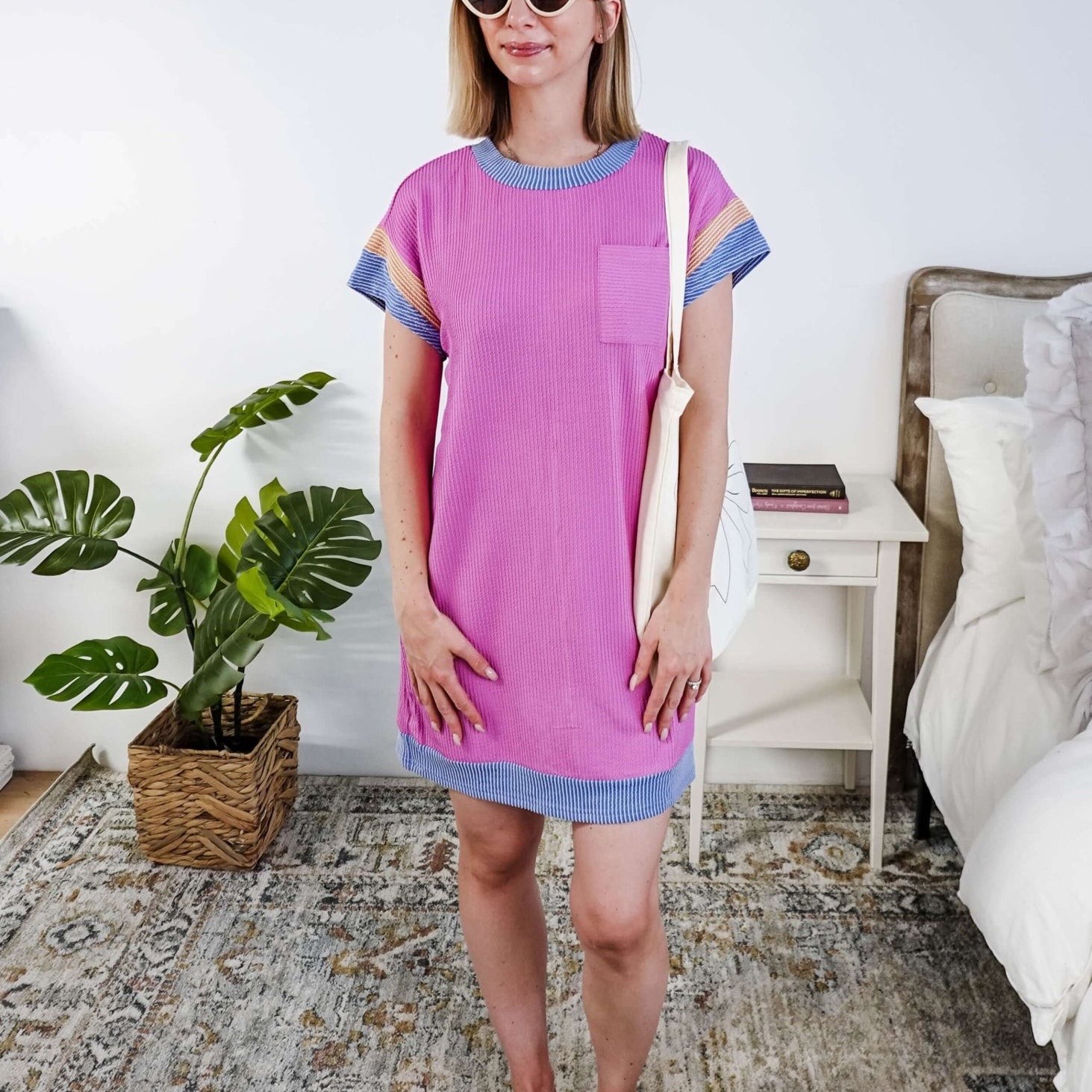 Woman wearing a pink dress with purple and peach sleeve dress in a bedroom setting, Scarlett Ellie Everyday Relaxed T-Shirt Dress | Cloud Nine Pajamas