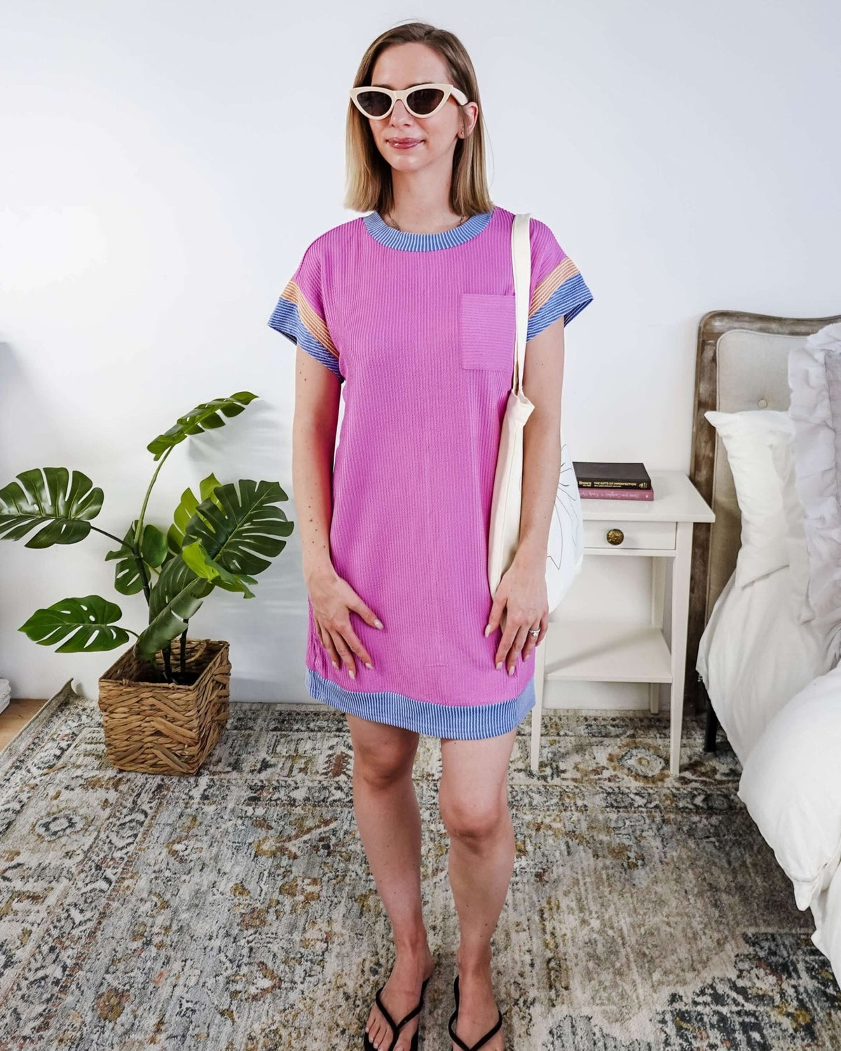 Woman wearing a pink dress with purple and peach sleeve dress in a bedroom setting, Scarlett Ellie Everyday Relaxed T-Shirt Dress | Cloud Nine Pajamas