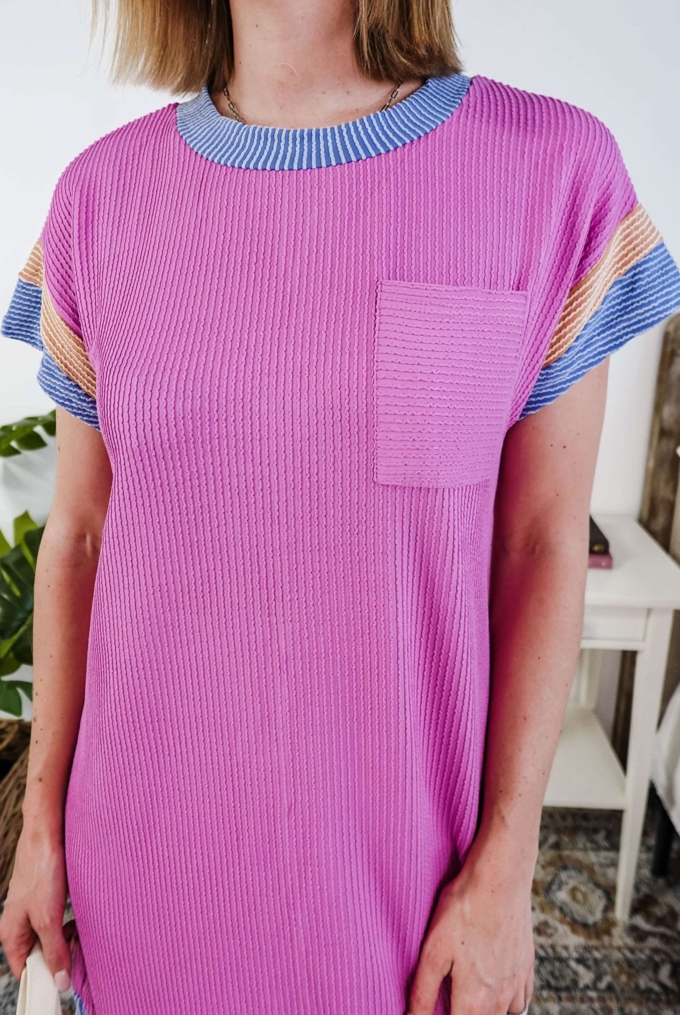 Woman wearing a pink dress with purple and peach sleeve dress in a bedroom setting, Scarlett Ellie Everyday Relaxed T-Shirt Dress | Cloud Nine Pajamas