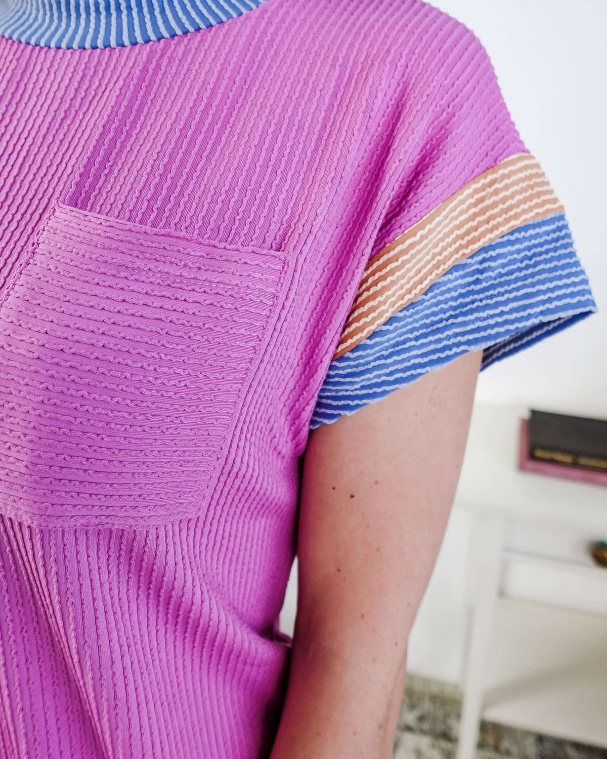 Close up of a woman wearing a pink dress with purple and peach sleeve dress with pocket in a bedroom setting, Scarlett Ellie Everyday Relaxed T-Shirt Dress | Cloud Nine Pajamas