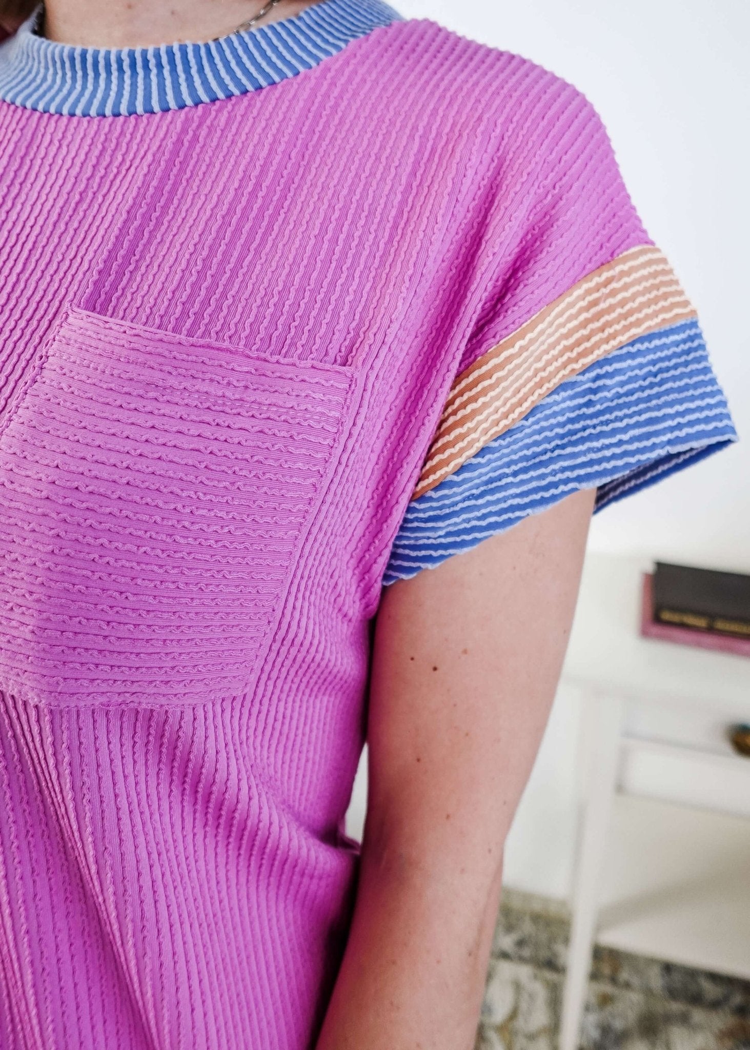 Close up of a woman wearing a pink dress with purple and peach sleeve dress with pocket in a bedroom setting, Scarlett Ellie Everyday Relaxed T-Shirt Dress | Cloud Nine Pajamas