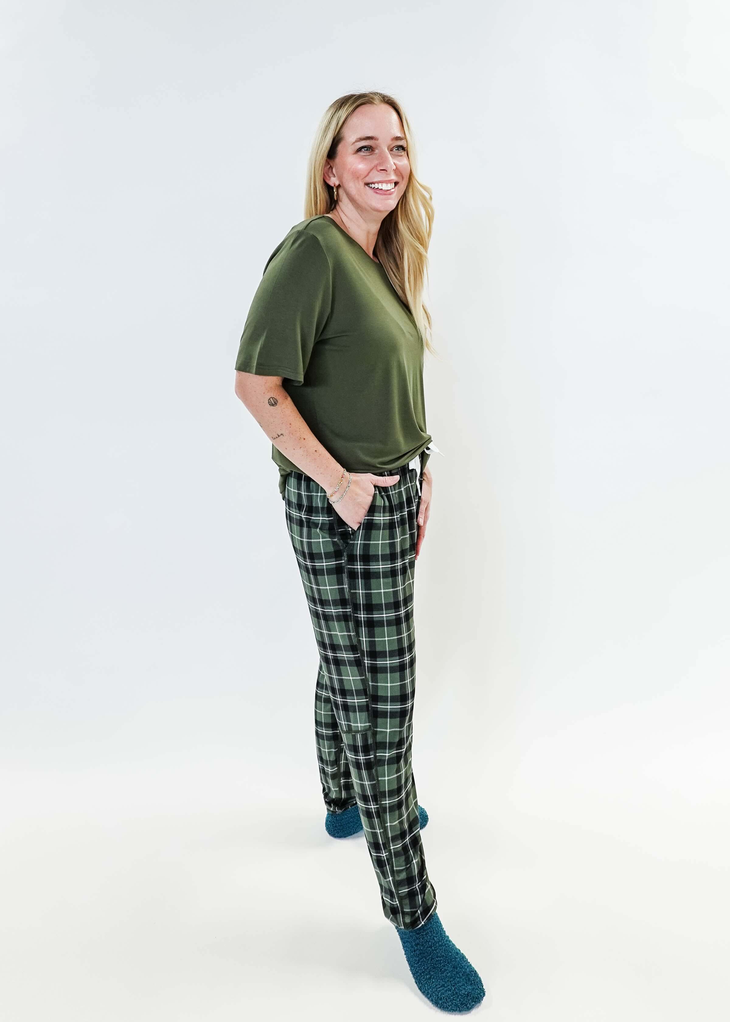 Woman in green top wearing Green Plaid Unisex Bamboo Jogger by Bob's Sleepwear Co. for ultimate comfort.
