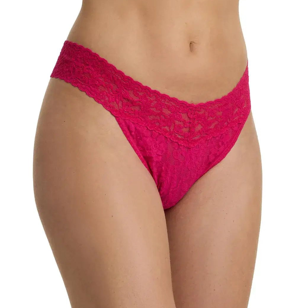 Hanky Panky Original Rise Thong in bright pink lace on a model's waist, showcasing signature lace design.