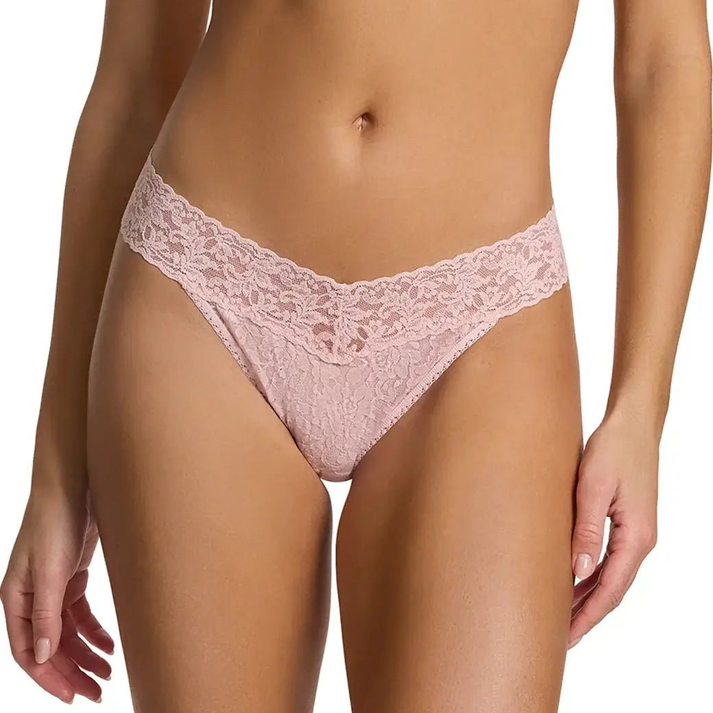 Hanky Panky Original Rise Thong in soft pink lace, featured on a model, showcasing signature lace design and comfortable fit.