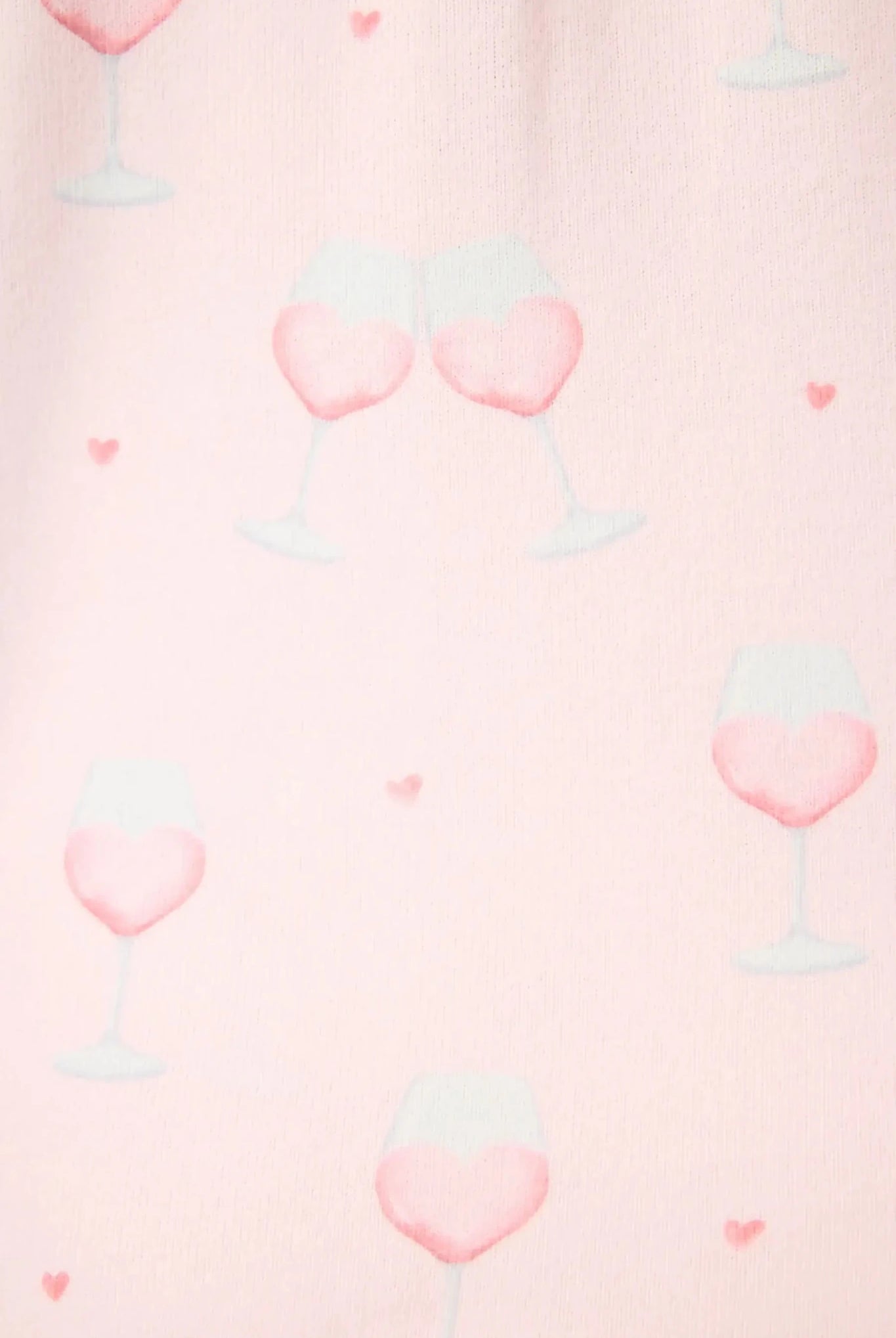 Happy Hour Wine Glass Print 3-Piece PJ Set | PJ Salvage women's wine glass print pj set in pink - button up long sleeve top, straight leg pants, and matching eye mask close up of the pink wine print, the "wine" looks like a heart and there are small hearts around the glass.