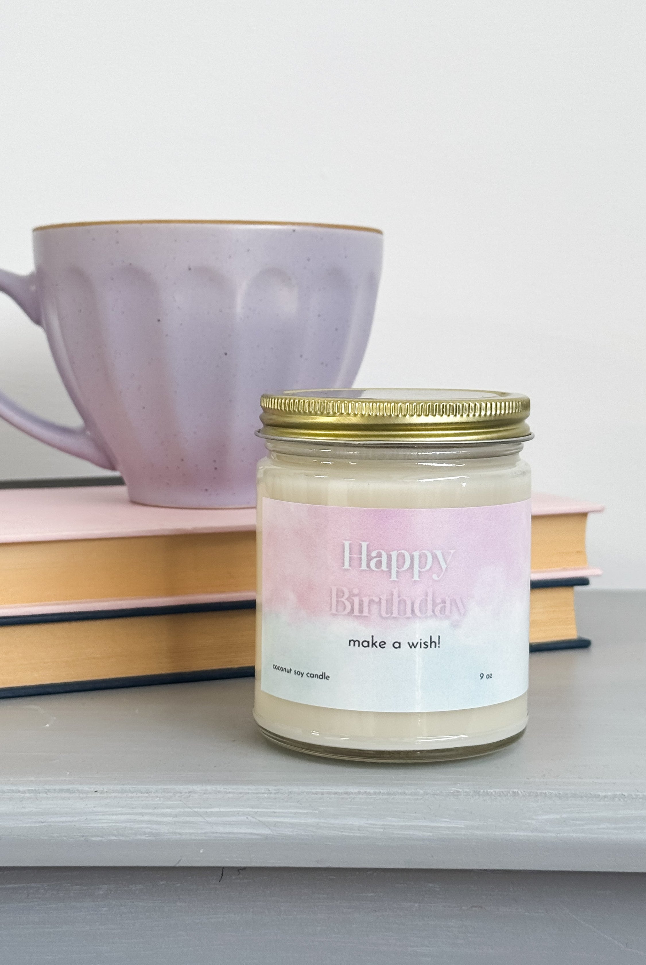 large coconut soy wax candle that says "happy birthday, make a wish!" - vanilla cake scented