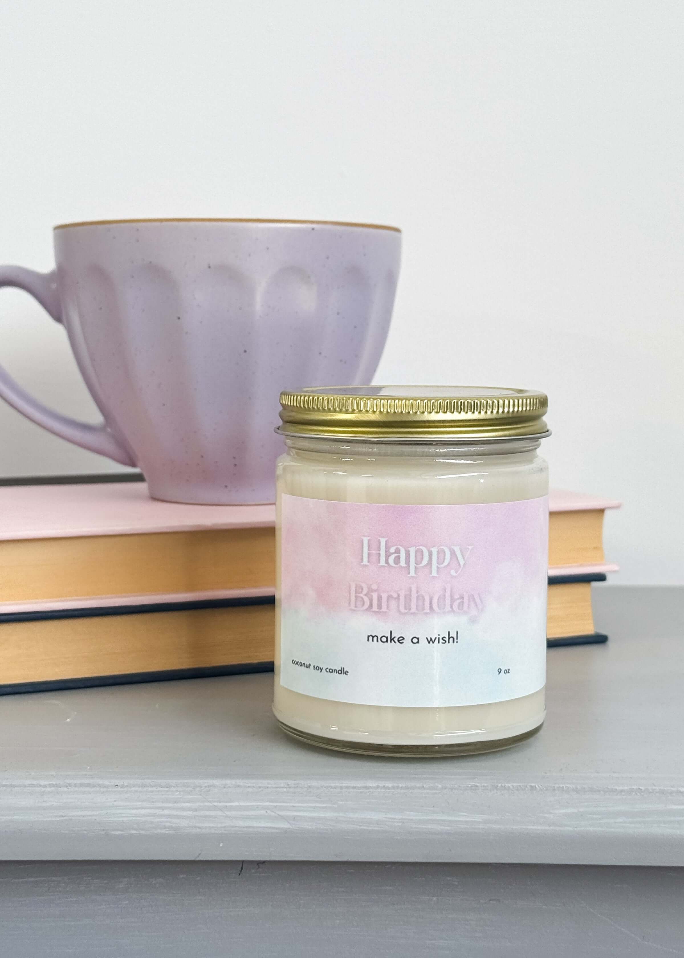 large coconut soy wax candle that says "happy birthday, make a wish!" - vanilla cake scented