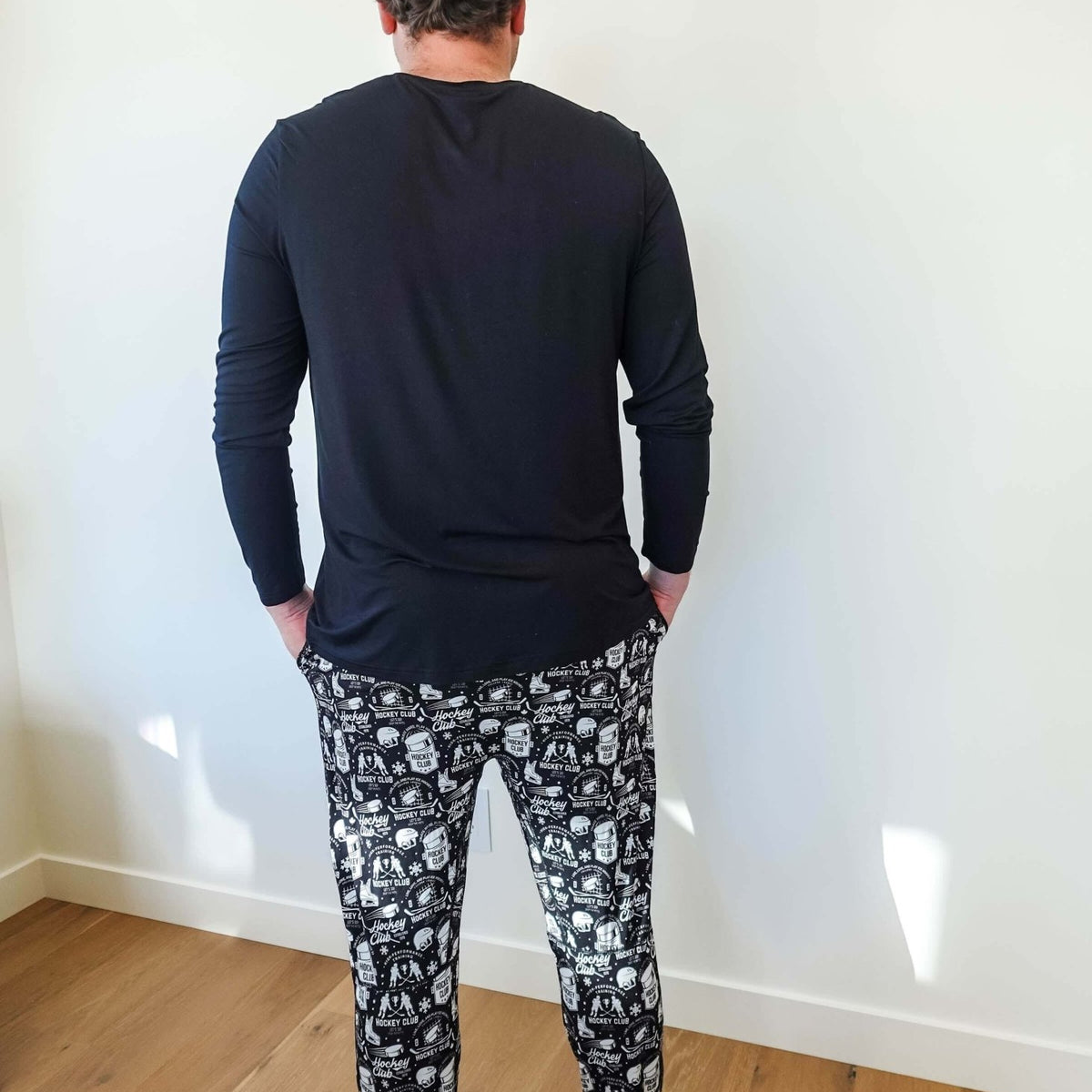 Man wearing He Scores Hockey Print Unisex Bamboo Jogger and long sleeve top from Bob’s Sleepwear Co.