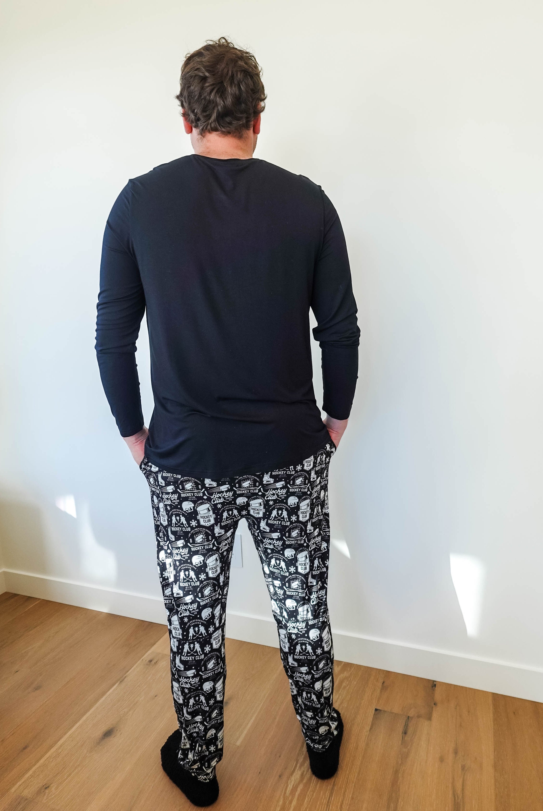 Man wearing He Scores Hockey Print Unisex Bamboo Jogger and long sleeve top from Bob’s Sleepwear Co.