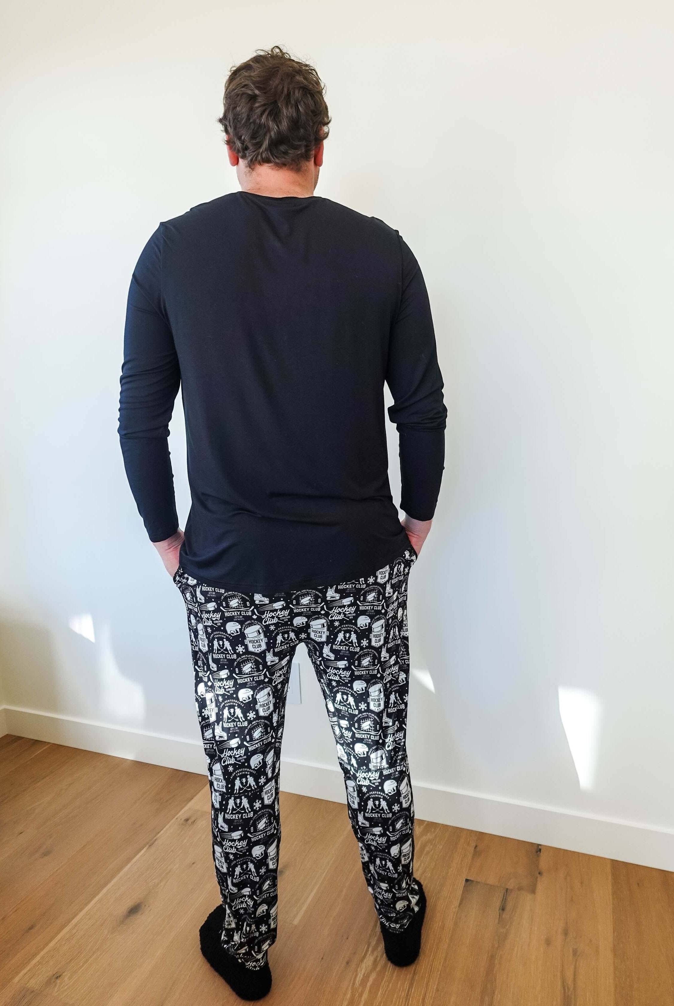 Man wearing He Scores Hockey Print Unisex Bamboo Jogger and long sleeve top from Bob’s Sleepwear Co.