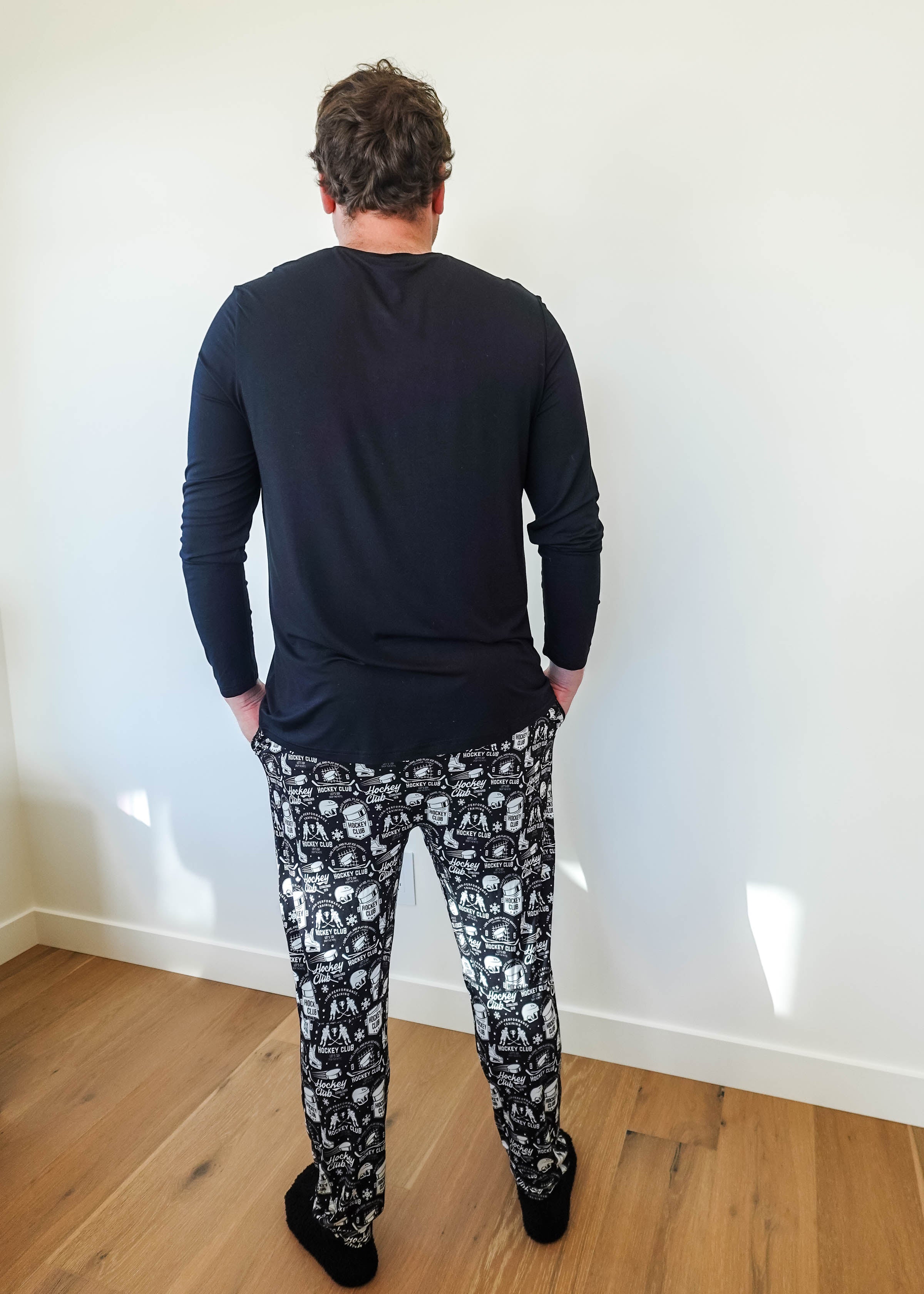 Man wearing He Scores Hockey Print Unisex Bamboo Jogger and long sleeve top from Bob’s Sleepwear Co.