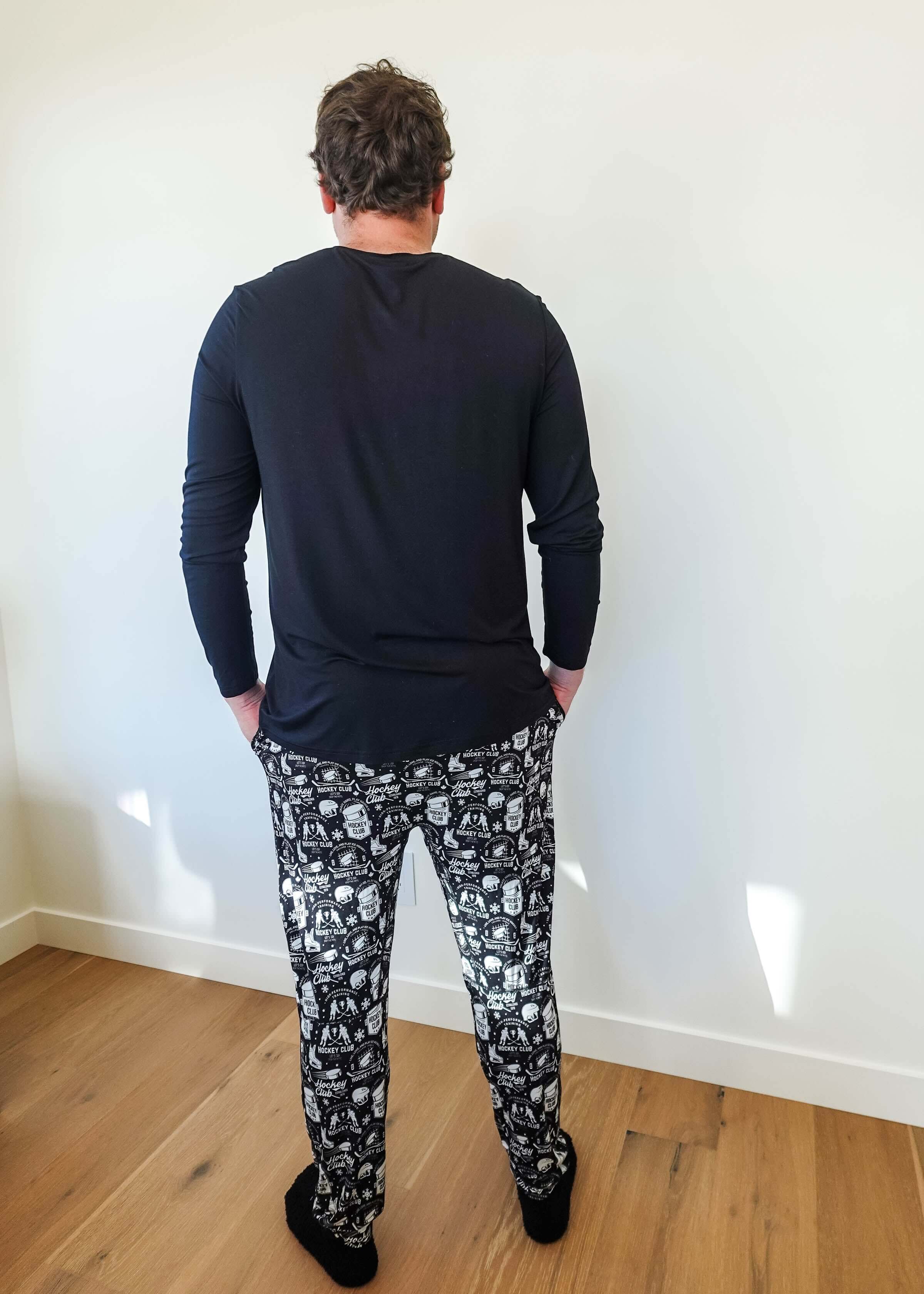 Man wearing He Scores Hockey Print Unisex Bamboo Jogger and long sleeve top from Bob’s Sleepwear Co.