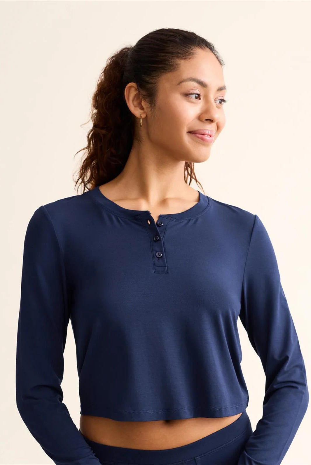 Model wearing the Ink Blue TENCEL™ Modal Cropped Henley Top. Highlighting the slight crop, functional buttons, and ribbed texture.