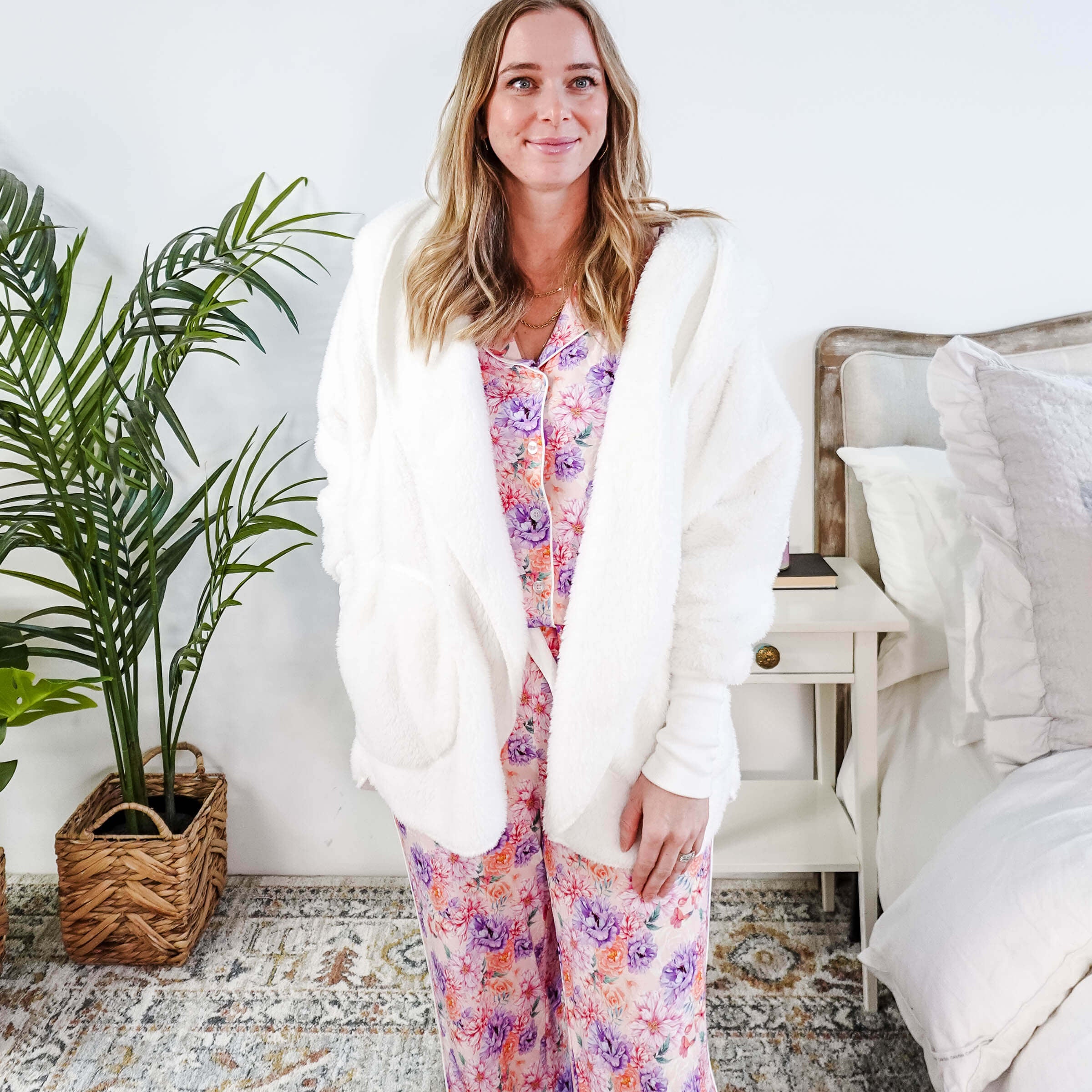 Essential Hooded Fluffy Cozy Cardigan with Pockets worn by a woman with floral pajamas in a cozy bedroom setting.