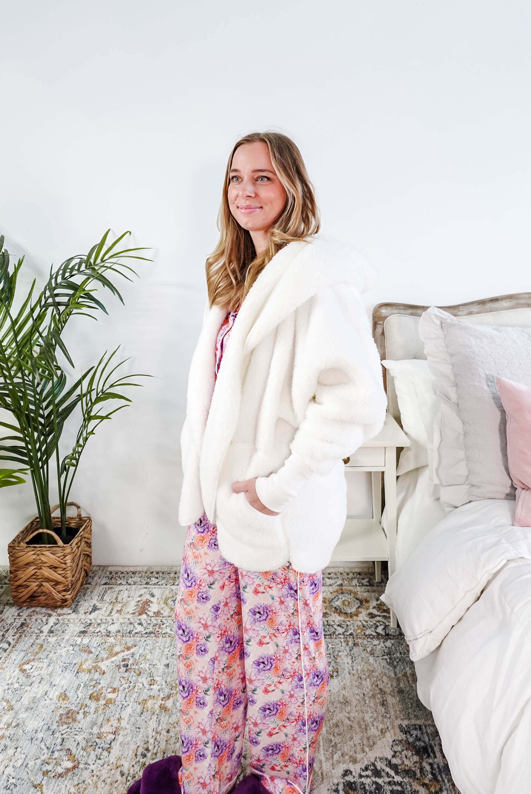 Essential Hooded Fluffy Cozy Cardigan with Pockets worn by a woman with floral pajamas in a cozy bedroom setting.