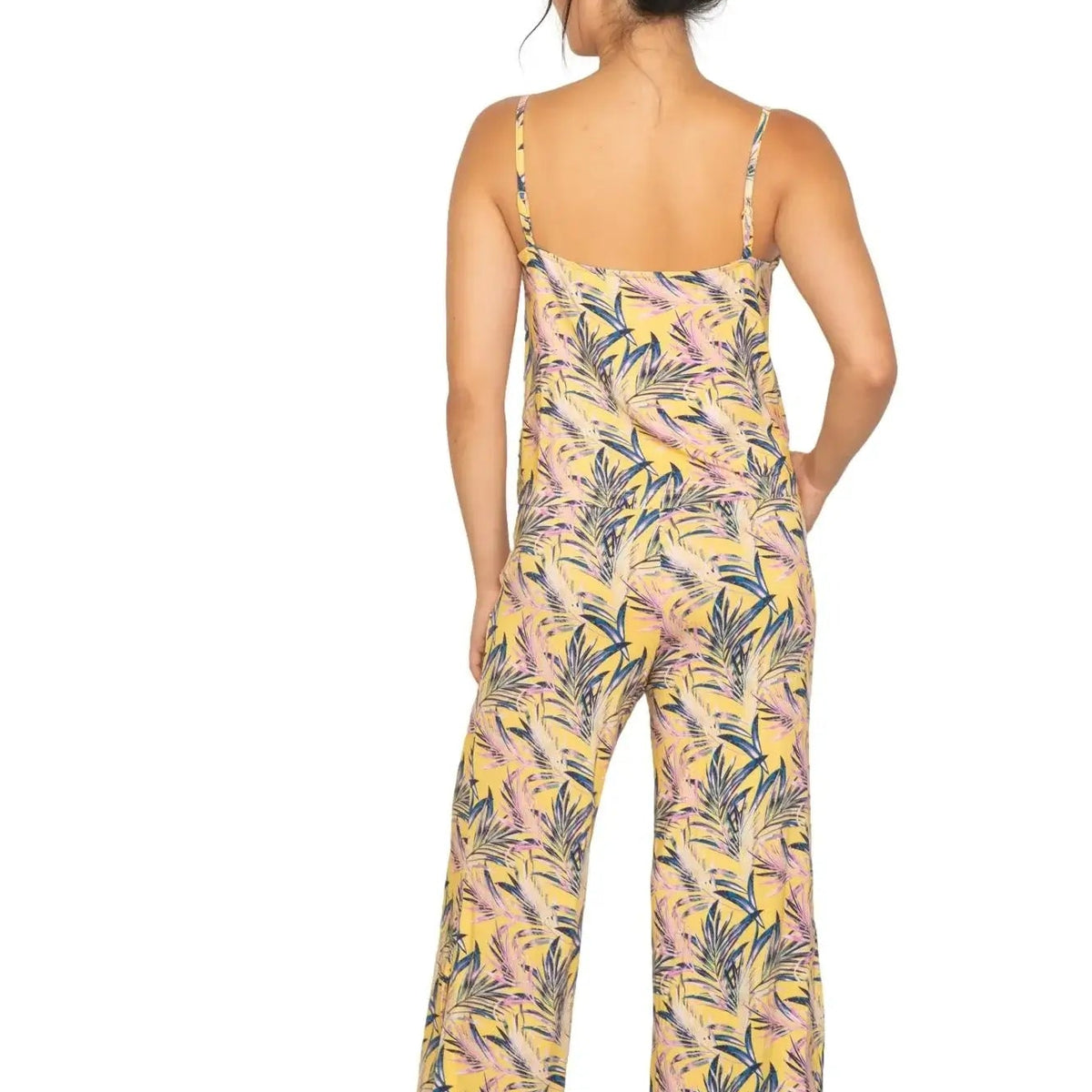 Back view of a model wearing the Cami & High Waist Capri PJ Set with a tropical print.