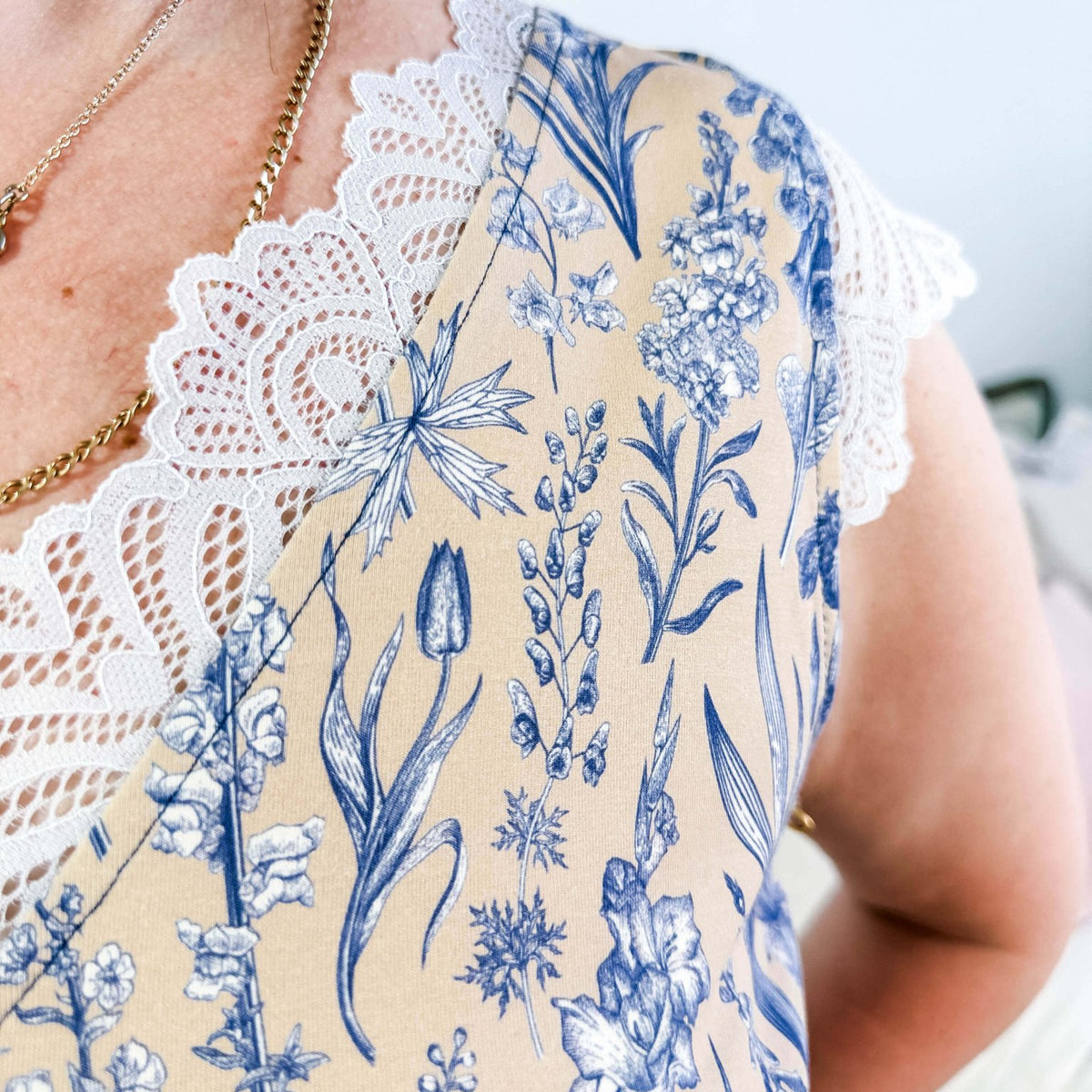 LATTE LOVE — Lace Sleep Dress in Linen Garden worn on model in bedroom setting, showing close up of the lace and floral pattern