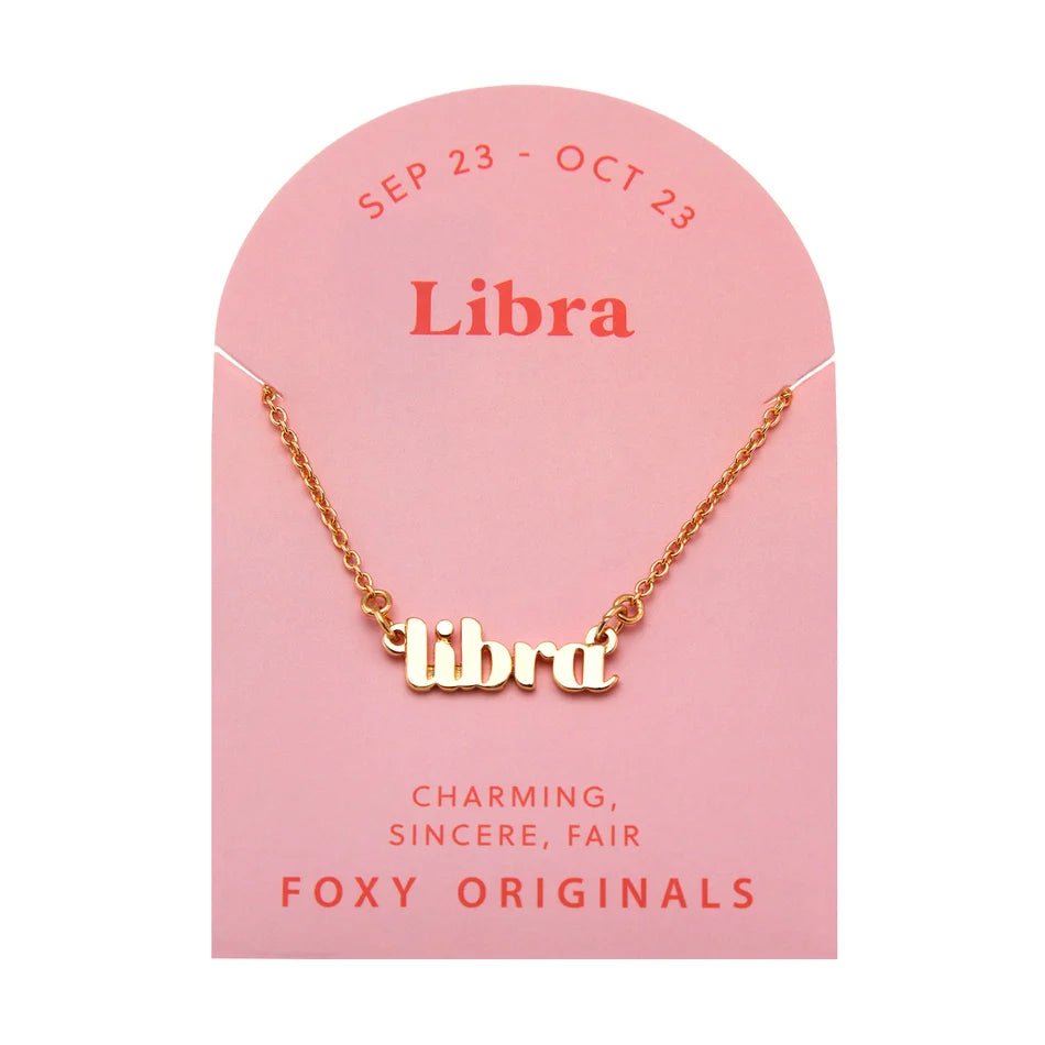 Zodiac Script Necklace in 14K Plated Gold featuring the astrological sign Libra on a pink card by Foxy Originals.