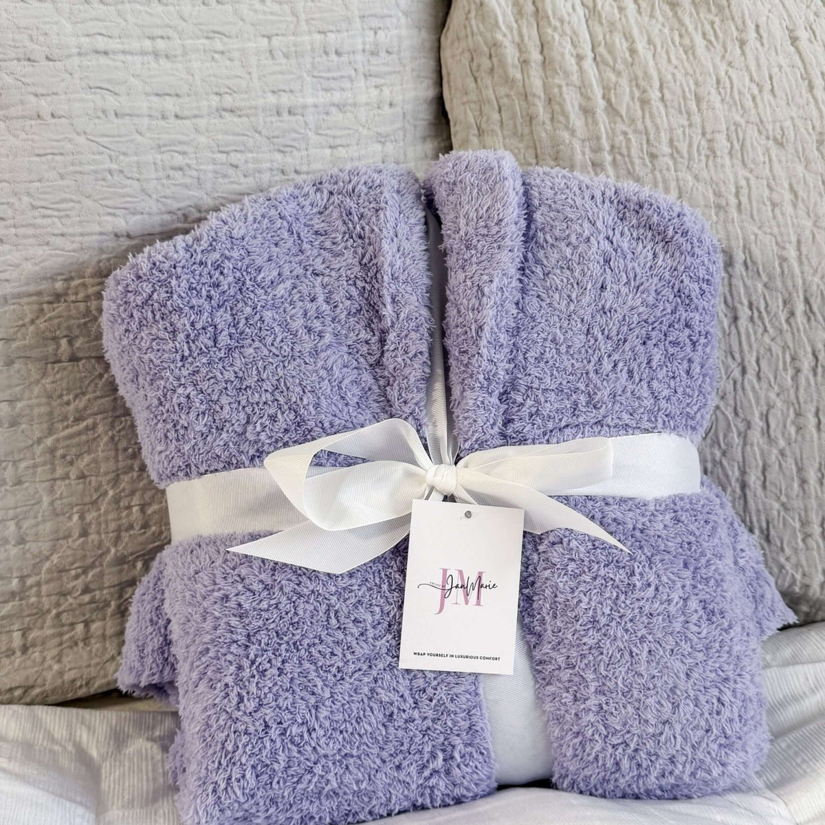 Lavender Chenille Cloud Spa Robe – Plush Stretch Robe with Pockets showing gift presentation, robe is wrapped with a white fabric ribbon and folded in a neat square.
