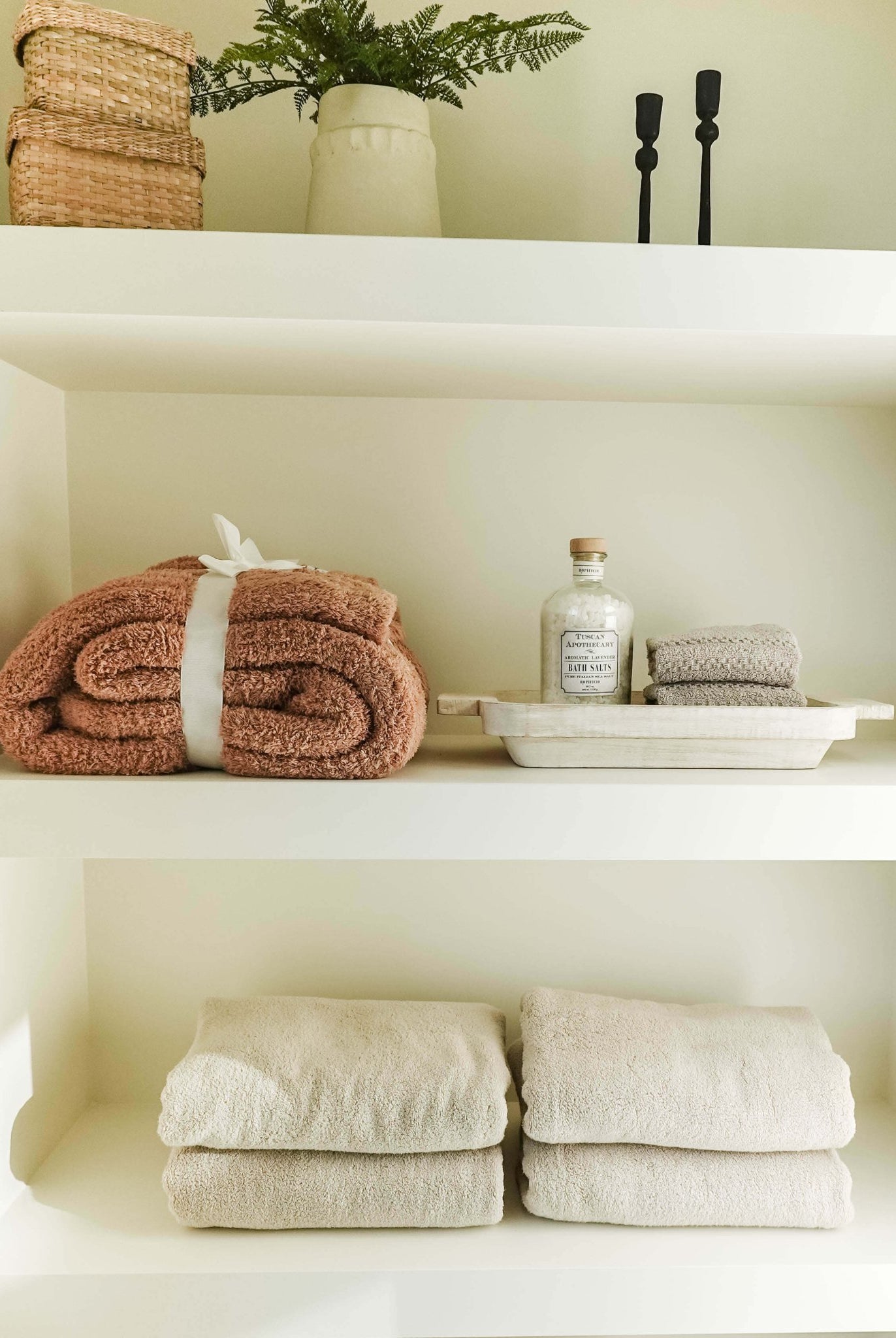 Mocha Brown Cozy Cabin Blanket shown on shelf in a luxury bathroom