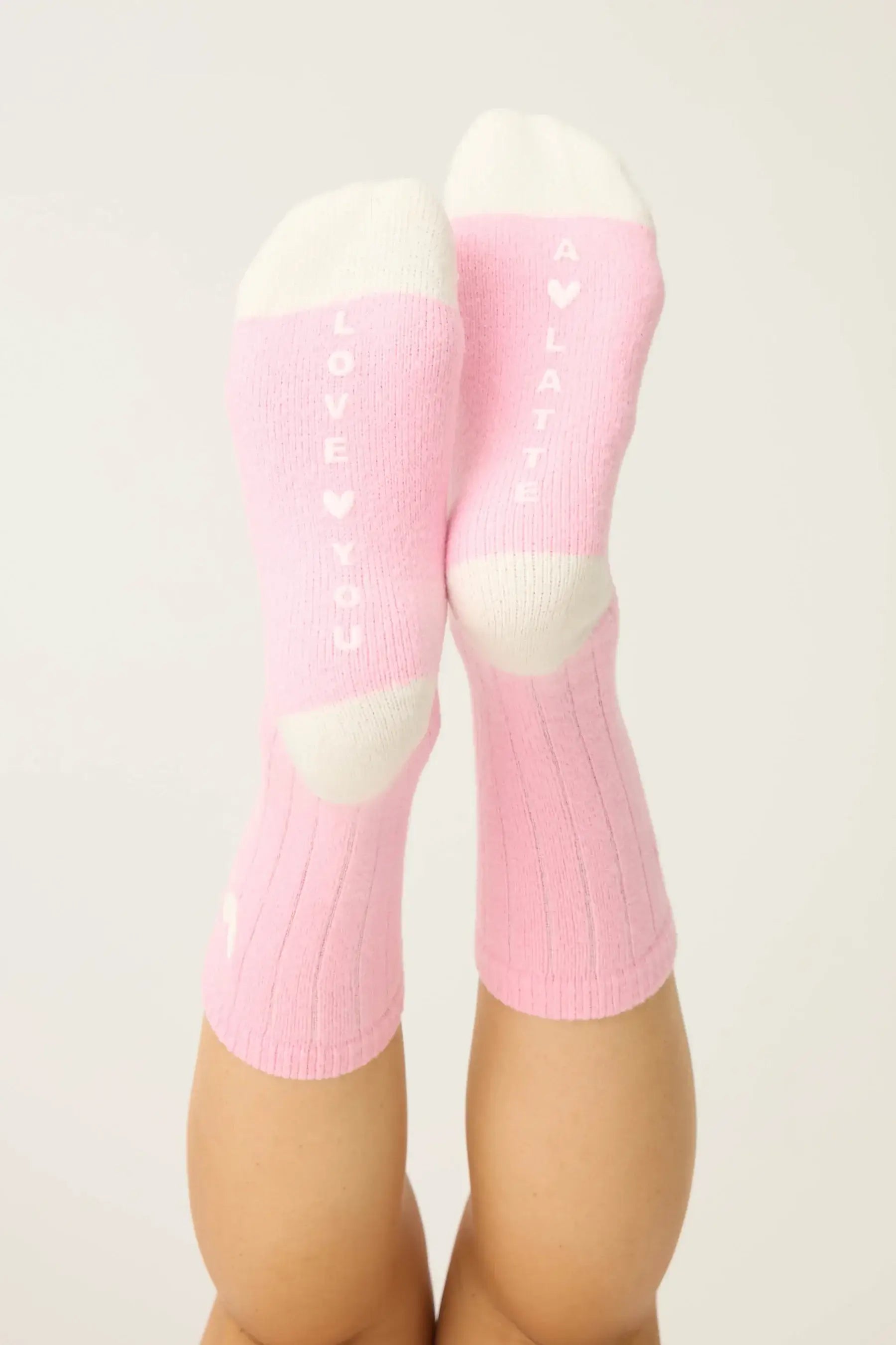 Pair of PJ Salvage Bright Pink Love you Latte Heart Crew Socks with a white contrast toe and heel, showing the sweet heart graphic above the ankle.