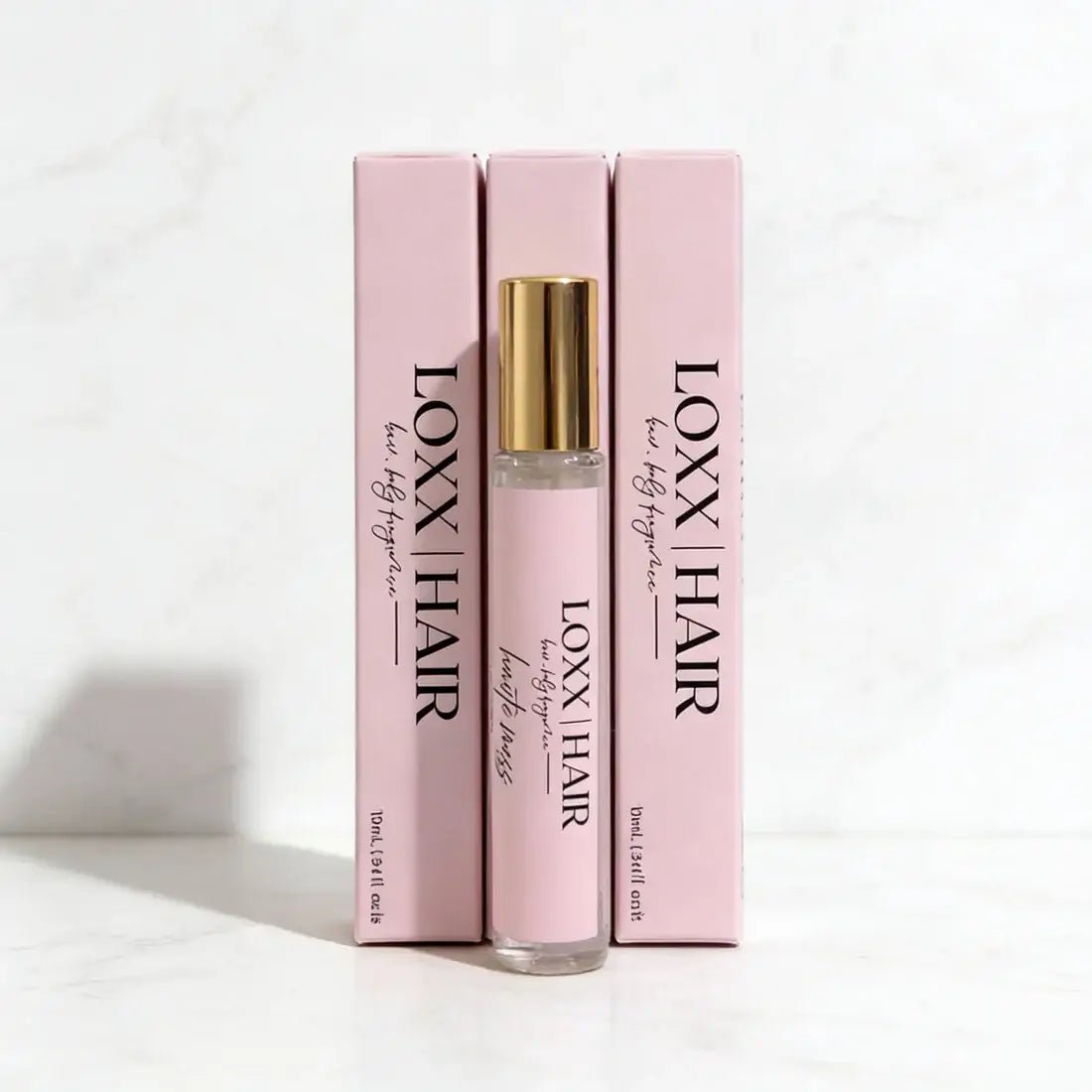 LOXX Haute Mess Hair & Body Fragrance – 10mL Travel Size in elegant packaging with gold accents.
