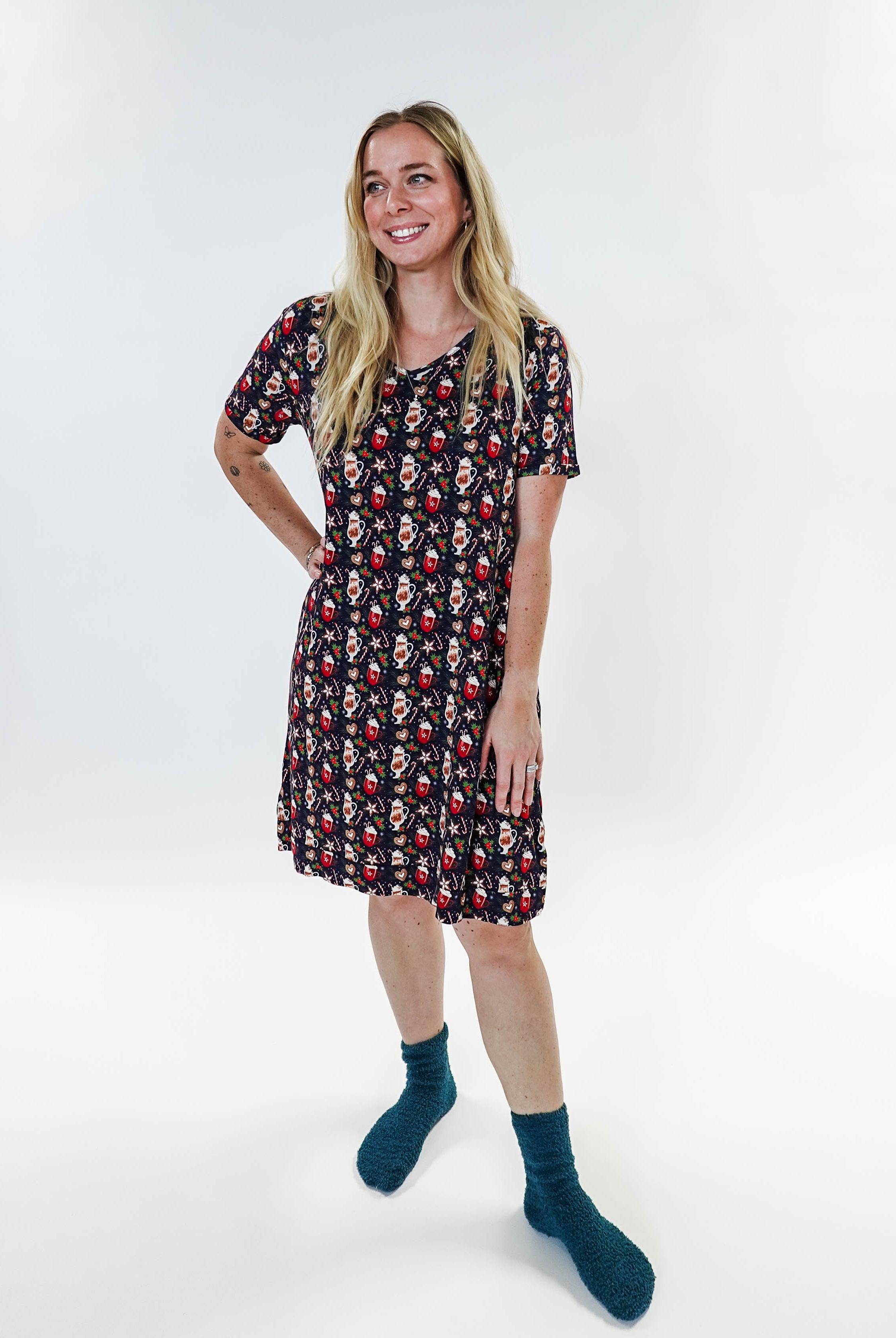 Merry Mugs V-Neck Bamboo Nightshirt featuring a whimsical holiday print, modeled by a woman standing with a cheerful expression.