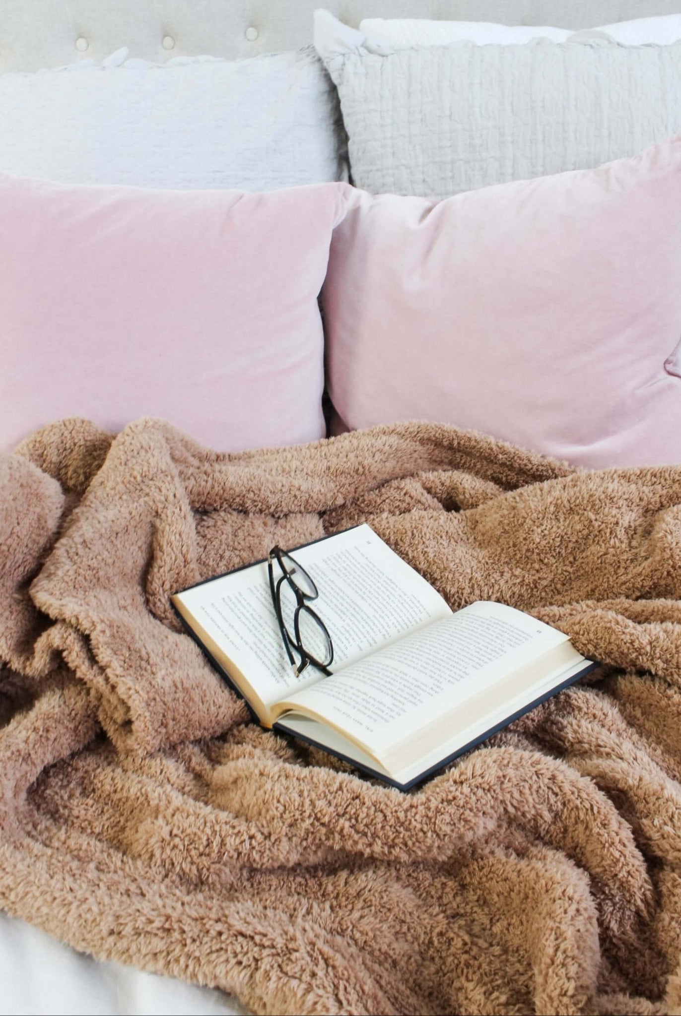 Mocha Brown Cozy Cabin Blanket Open book with glasses on a fluffy brown blanket on a bed with pink pillows.