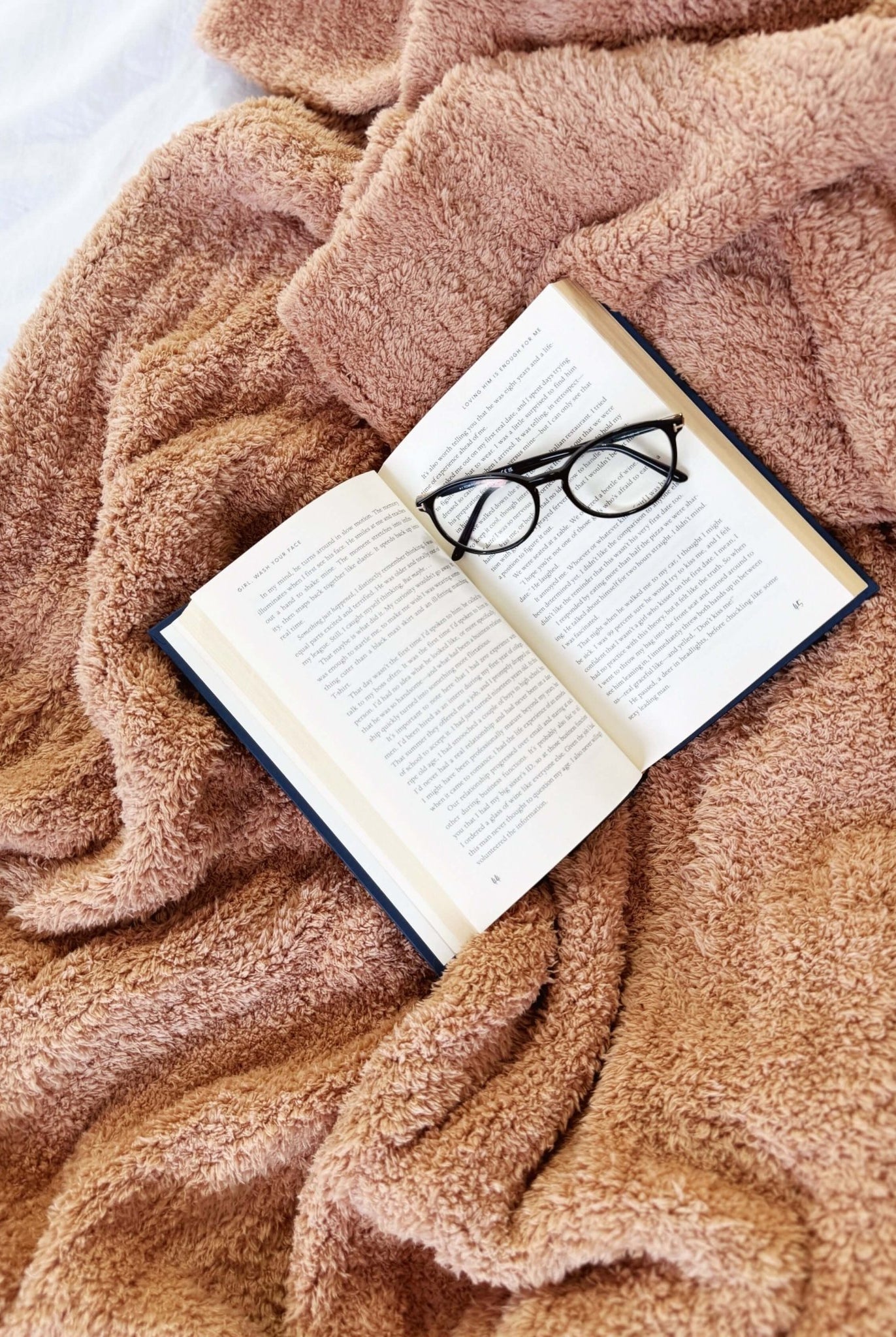Mocha Brown Cozy Cabin Blanket laid across a bed with a book