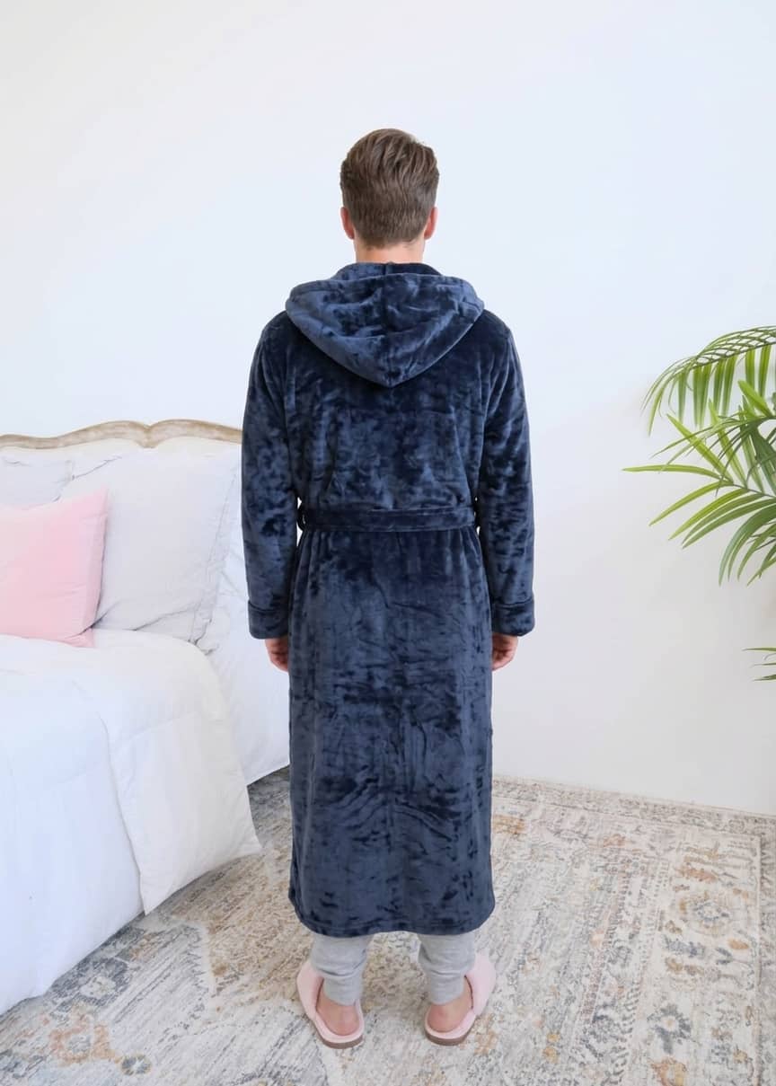 Long Navy Hooded Fleece Robe on male model in bedroom setting back view - Cloud Nine Pajamas