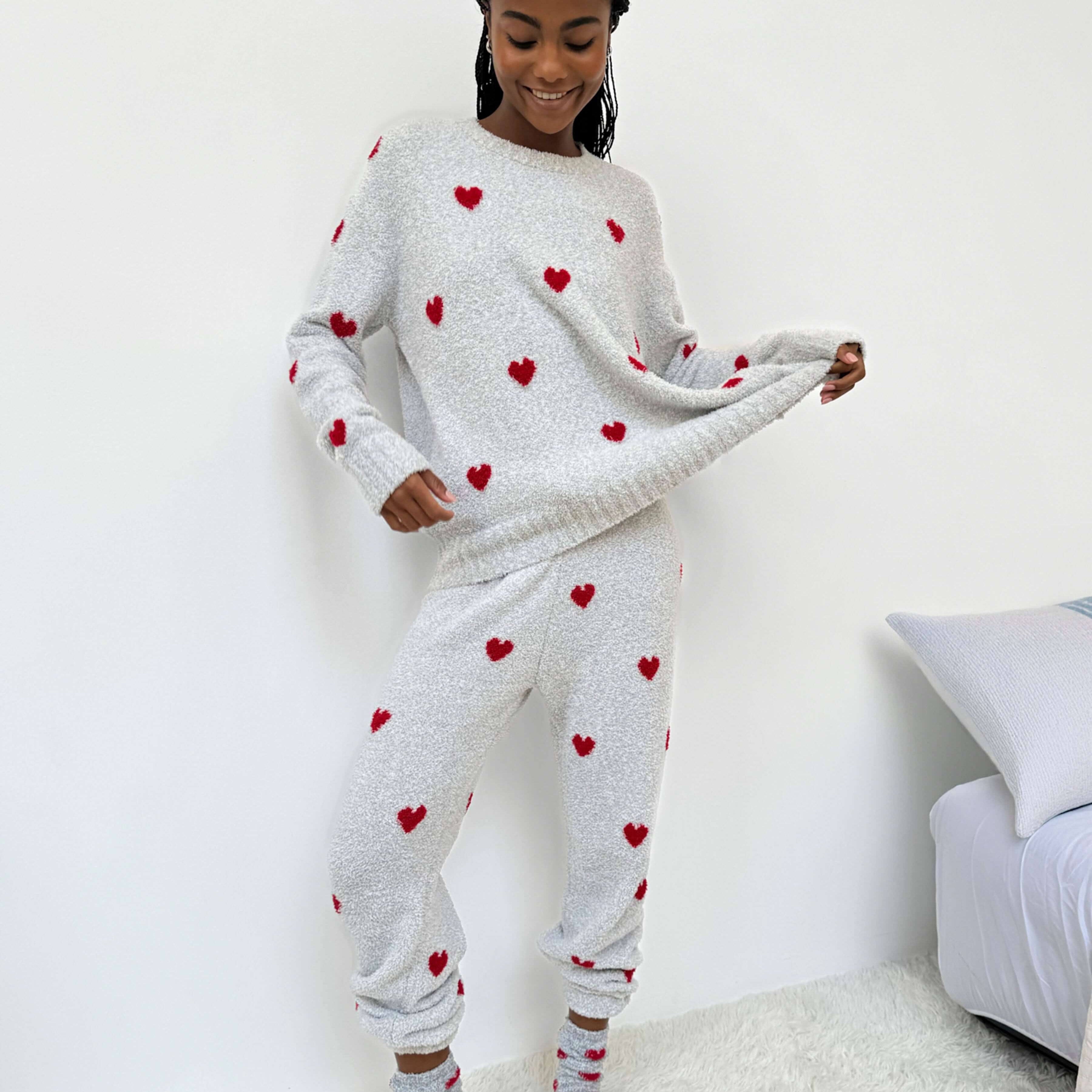 Woman wearing Cloud-Soft Fuzzy Sweater Pajama Set Splendid with heart patterns, showcasing cozy loungewear style.