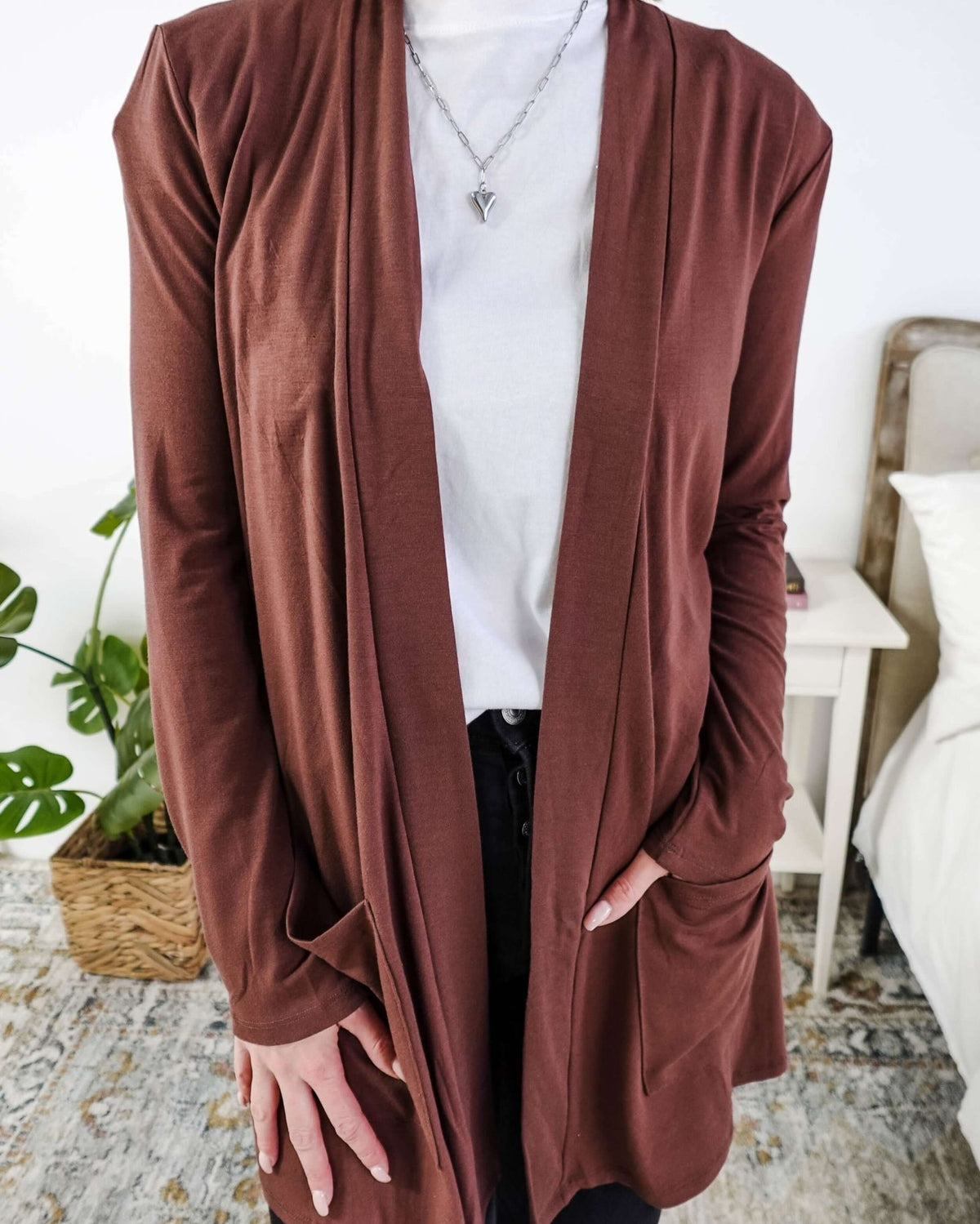 Person wearing a brown cardigan over a white shirt in a casual setting. Scarlett Ellie Summer Open Lightweight Cardigan | Cloud Nine Pajamas