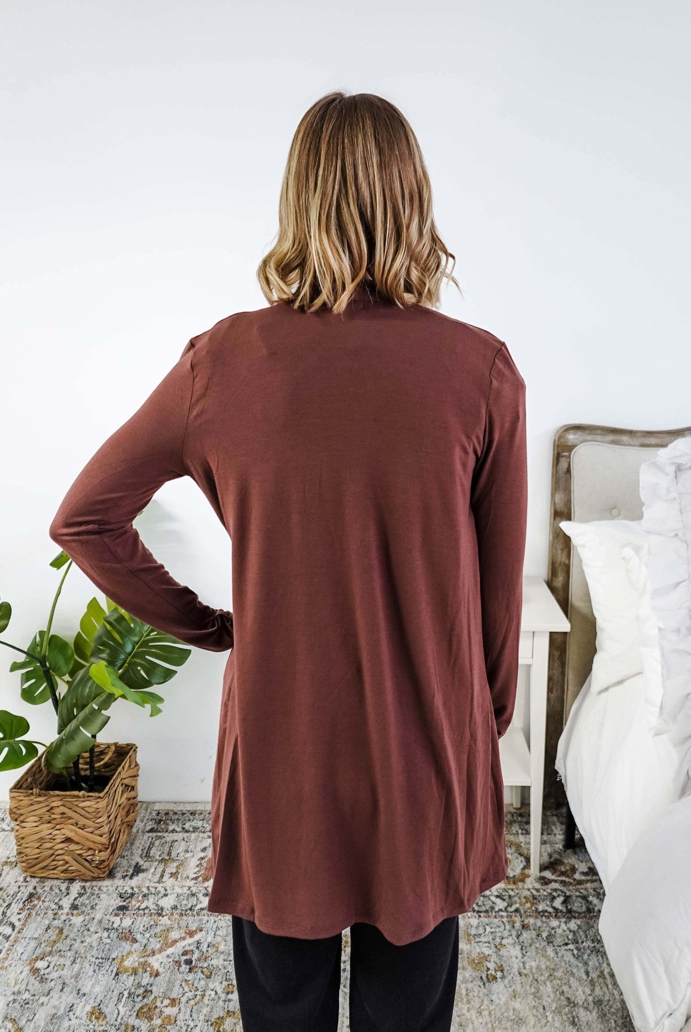 Person wearing a brown long-sleeve cardigan in a bedroom setting Scarlett Ellie Summer Open Lightweight Cardigan | Cloud Nine Pajamas