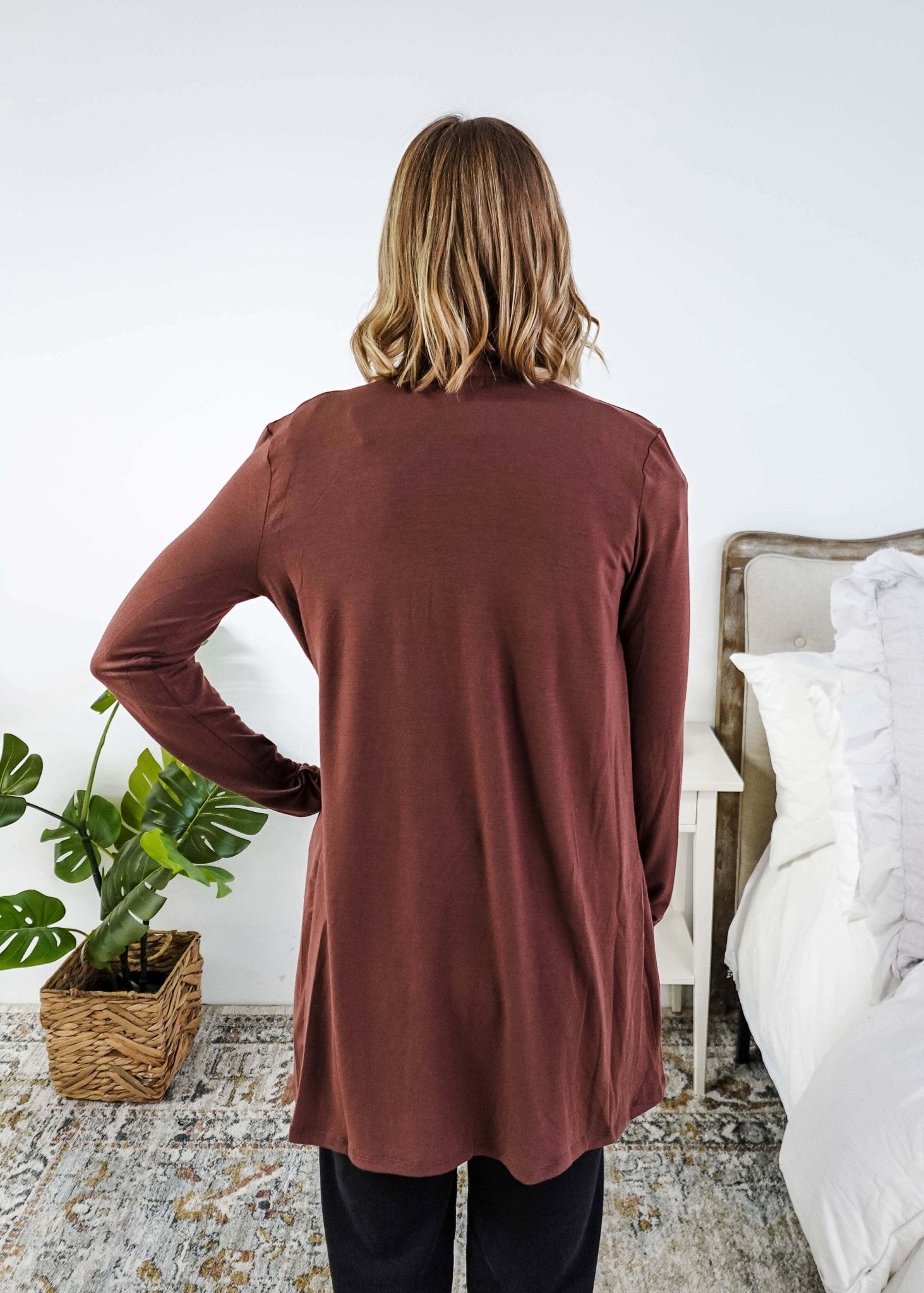 Person wearing a brown long-sleeve cardigan in a bedroom setting Scarlett Ellie Summer Open Lightweight Cardigan | Cloud Nine Pajamas